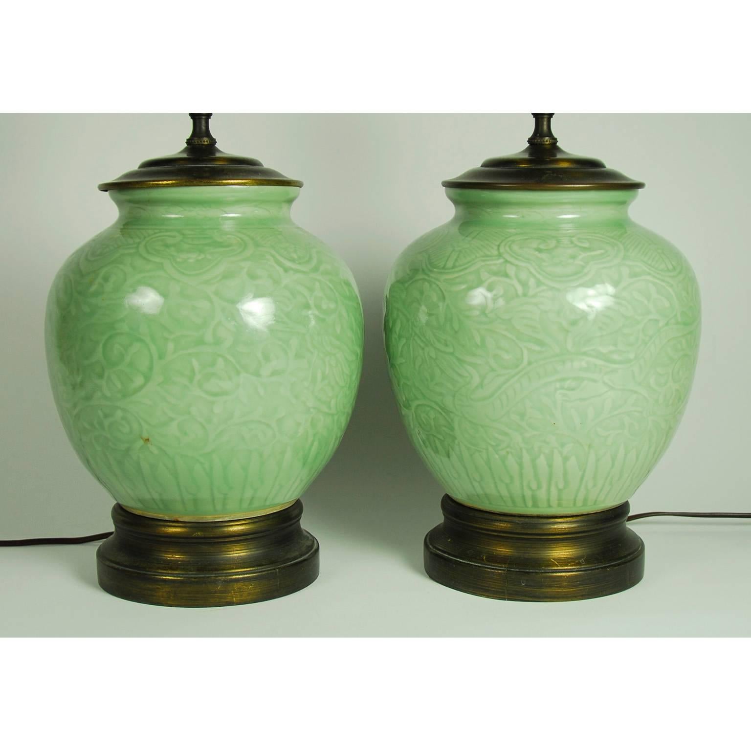 Pair of Chinese Celadon porcelain ginger jars, now fitted as lamps. Mounted on brass base with different jadite finials. Without shades, 19th century.
