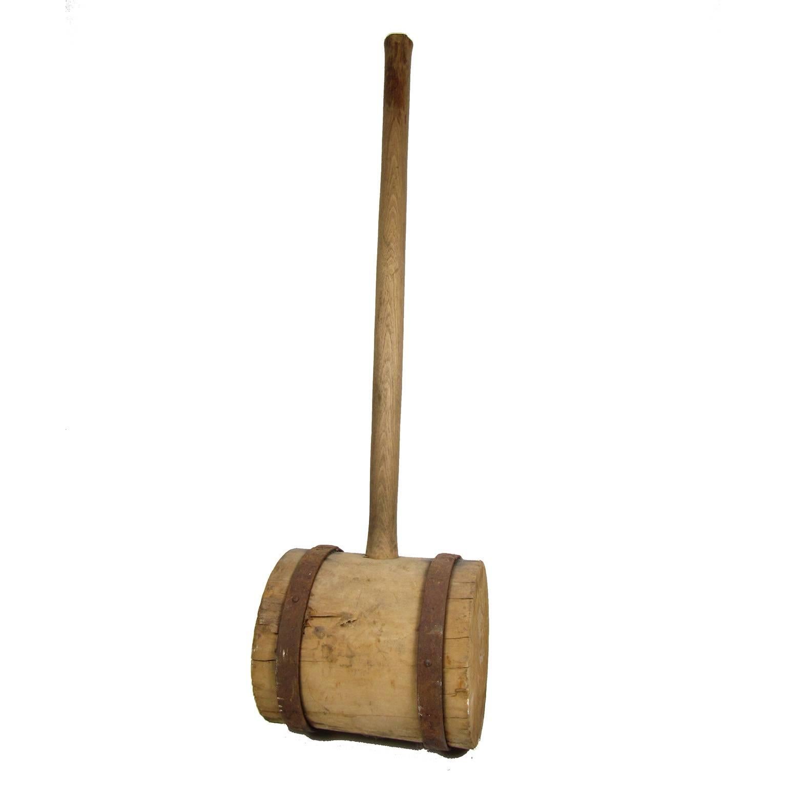 Large antique iron banded wood carnival strongman's mallet. Measures: Length 35 3/4 inches, height 9 1/2 inches, diameter 8 inches. Terrific object.