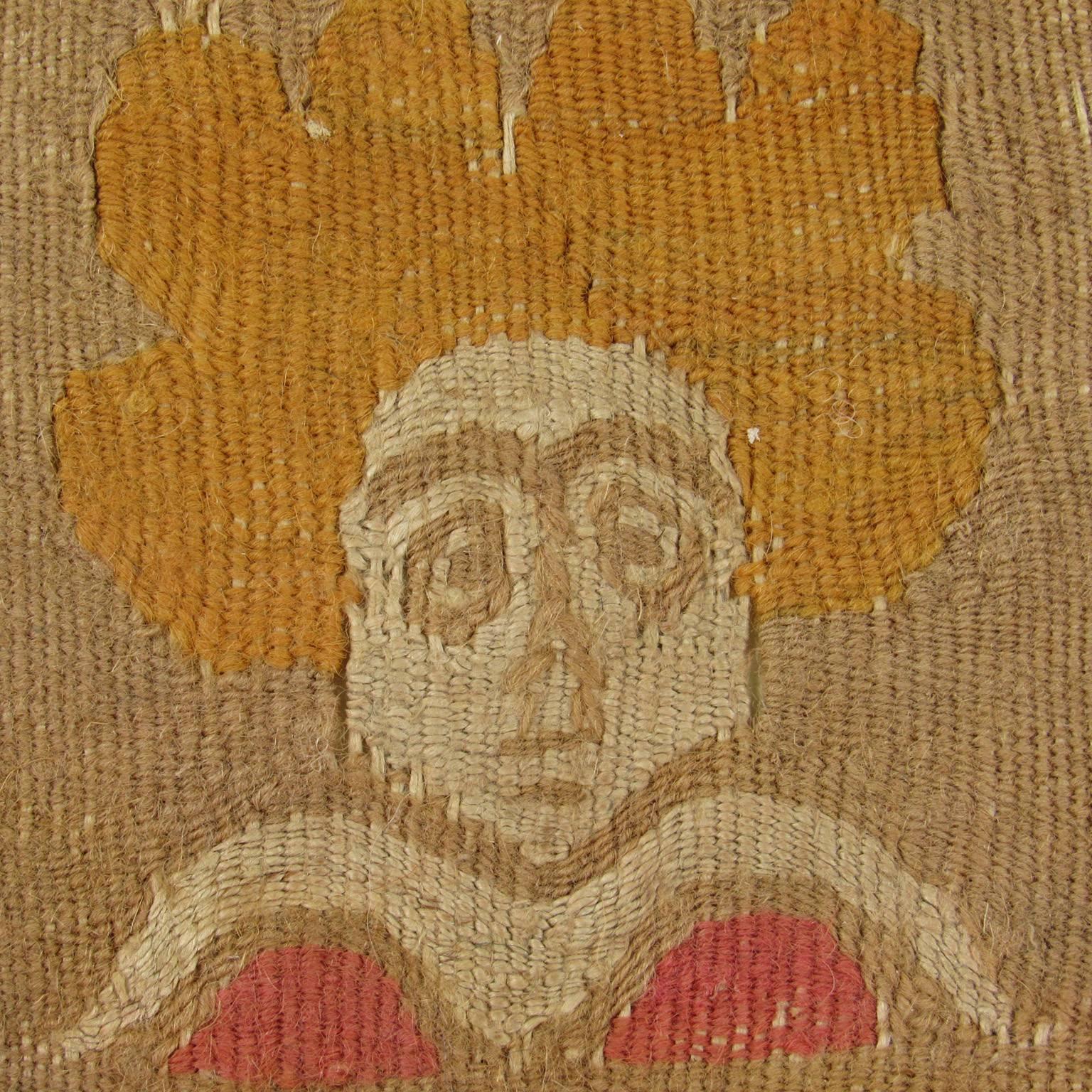 Ancient Coptic Portrait Textile Fragment, Egypt, possibly 3-4 century. Unusually whimsical design!! Wool and linen tapestry fragment depicting the head of a woman with blonde hair and large eyes, surrounded by a blue border with geometric