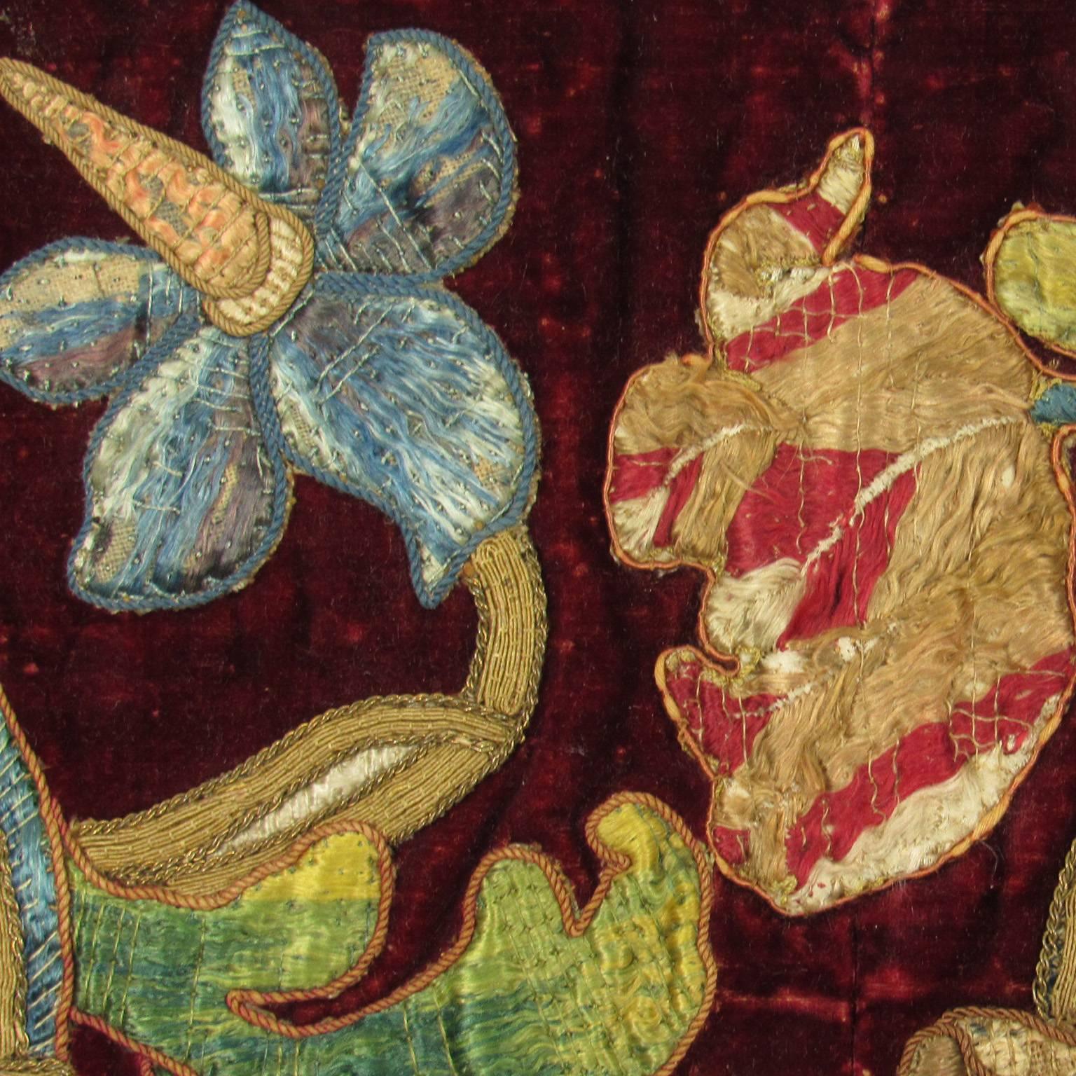 Continental Renaissance style couched silk and goldwork embroidered red velvet textile, late 18th to early 19th century. Colorful silk and gold threads form a beautiful floral and vine pattern against a deep red background with metallic thread