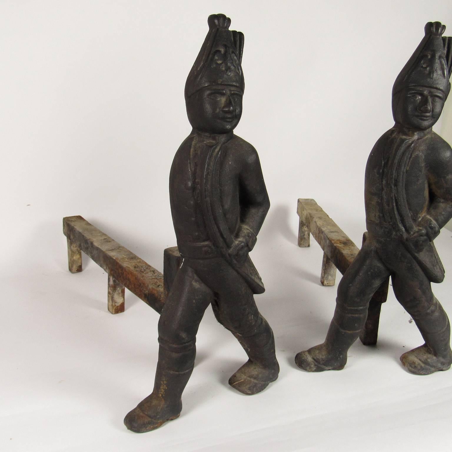 Pair of Hessian Soldier form cast iron andirons. Popular in the 19th century, this pair is unpainted with a nice surface. 
Measures: Height: 19 1/2 inches, width: 9 inches; firedog: 21 inches.