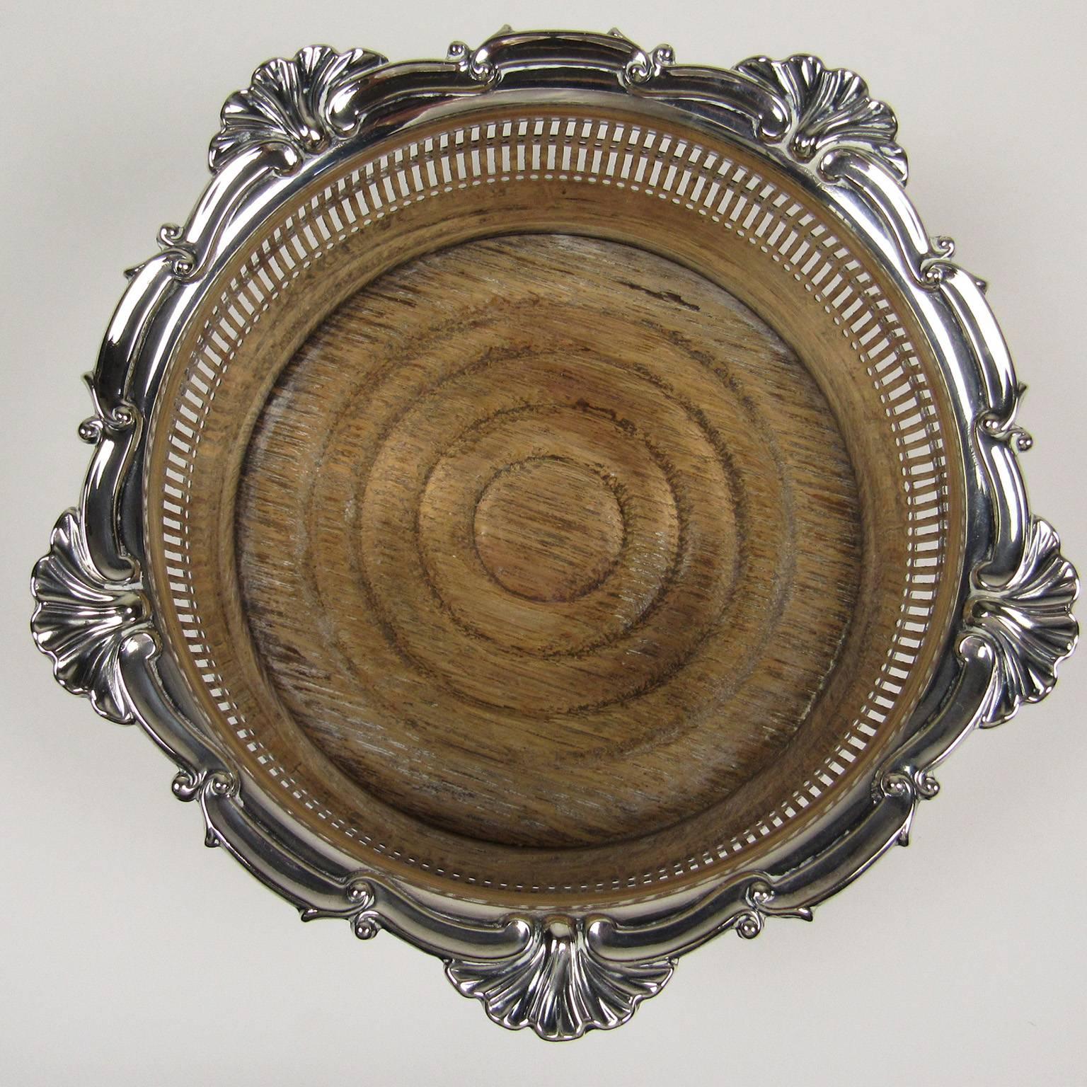 High quality pair of English William Adams reticulated silver plated wine coasters, early 20th century; marked Great Britain/40270 and W/\A; for William Adams. Measures: Diameter 6 3/8 inches, height 3 1/8 inches.