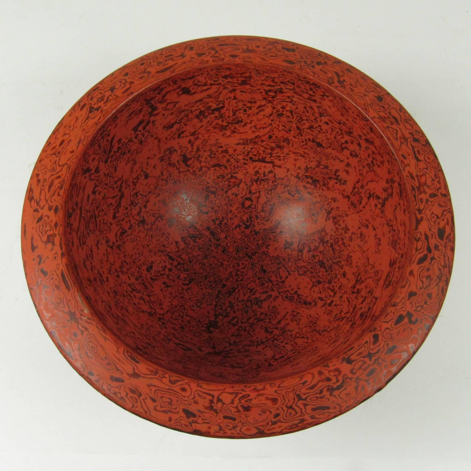 Midcentury Japanese red marbleized lacquer wide rimmed bowl, unmarked with black lacquer bottom. Measures: Diameter 9 1/2 in., height 4 in.