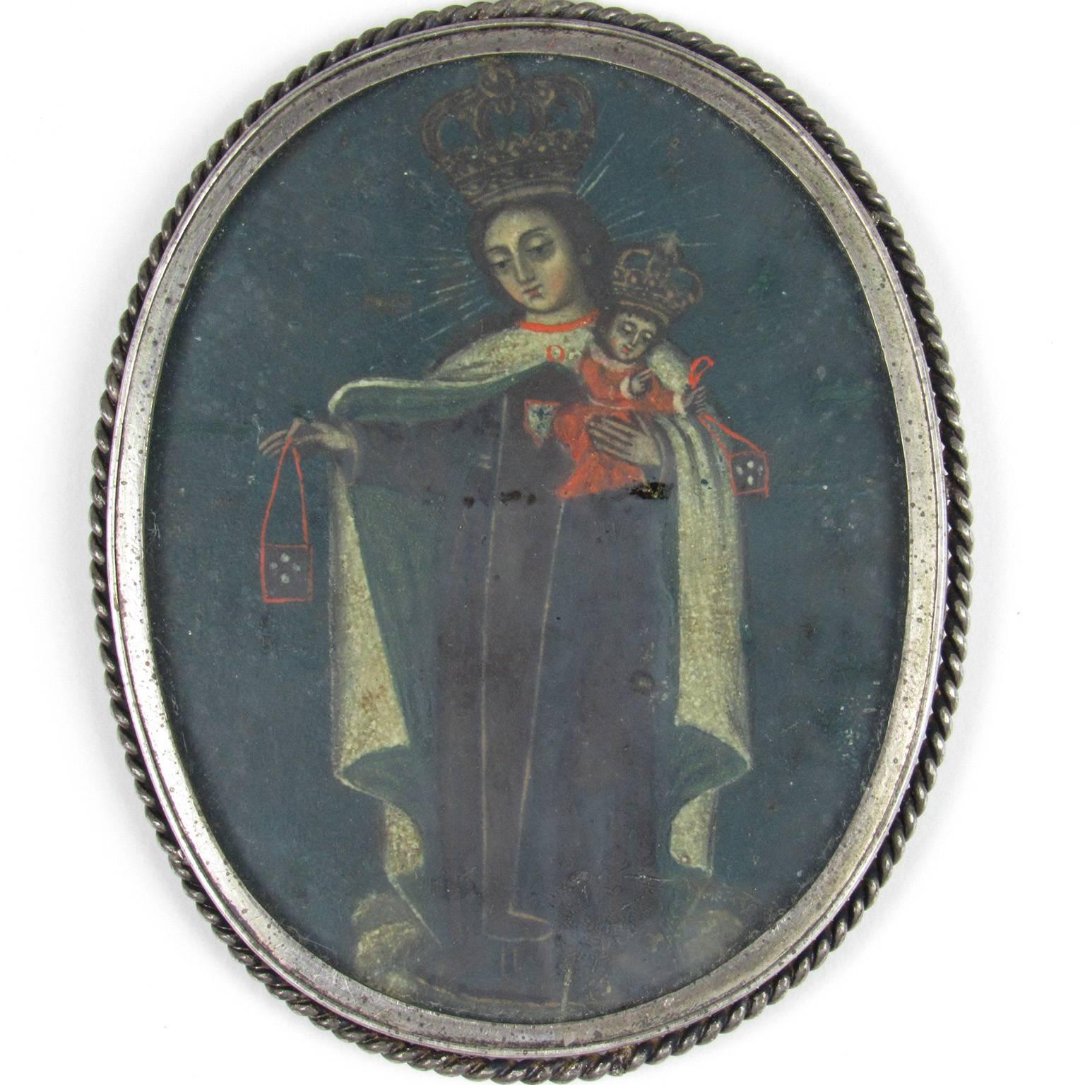 Rare early 19th century Spanish Colonial Two-Sided Reliquary, depicting the Madonna and Child on both sides.  One side features a figure of a man kneeling in prayer to Mary, Queen of Heaven.  Inscribed "A de Voci Mariane...Pe..."  lower