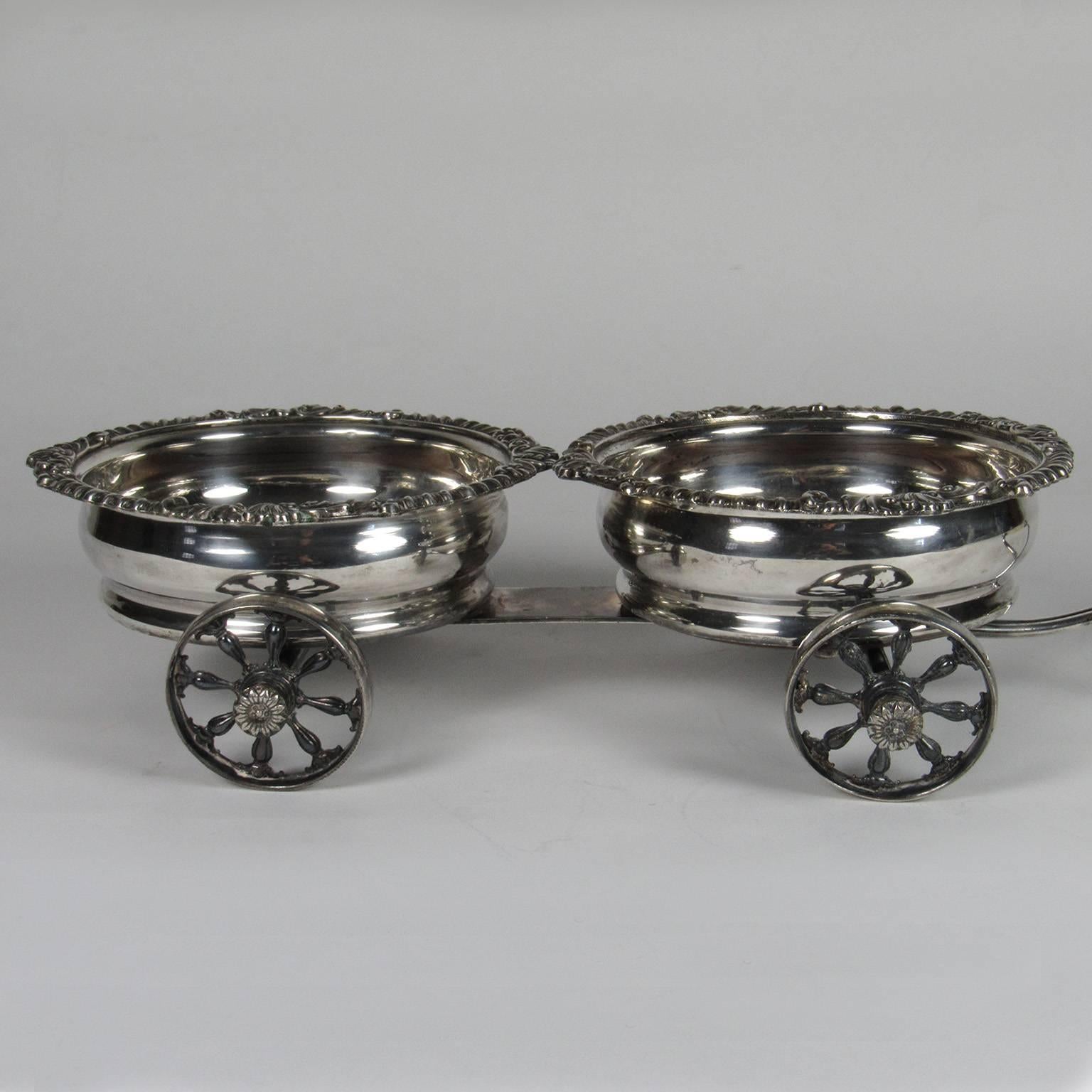 Unusual 19th century silver plate wine coaster trolley with ivory handle. British. Indiscernible stamp on bottom. Measures: Height: 3 1/4 in., length: 17 in., diameter of coaster: 6 1/4 in.