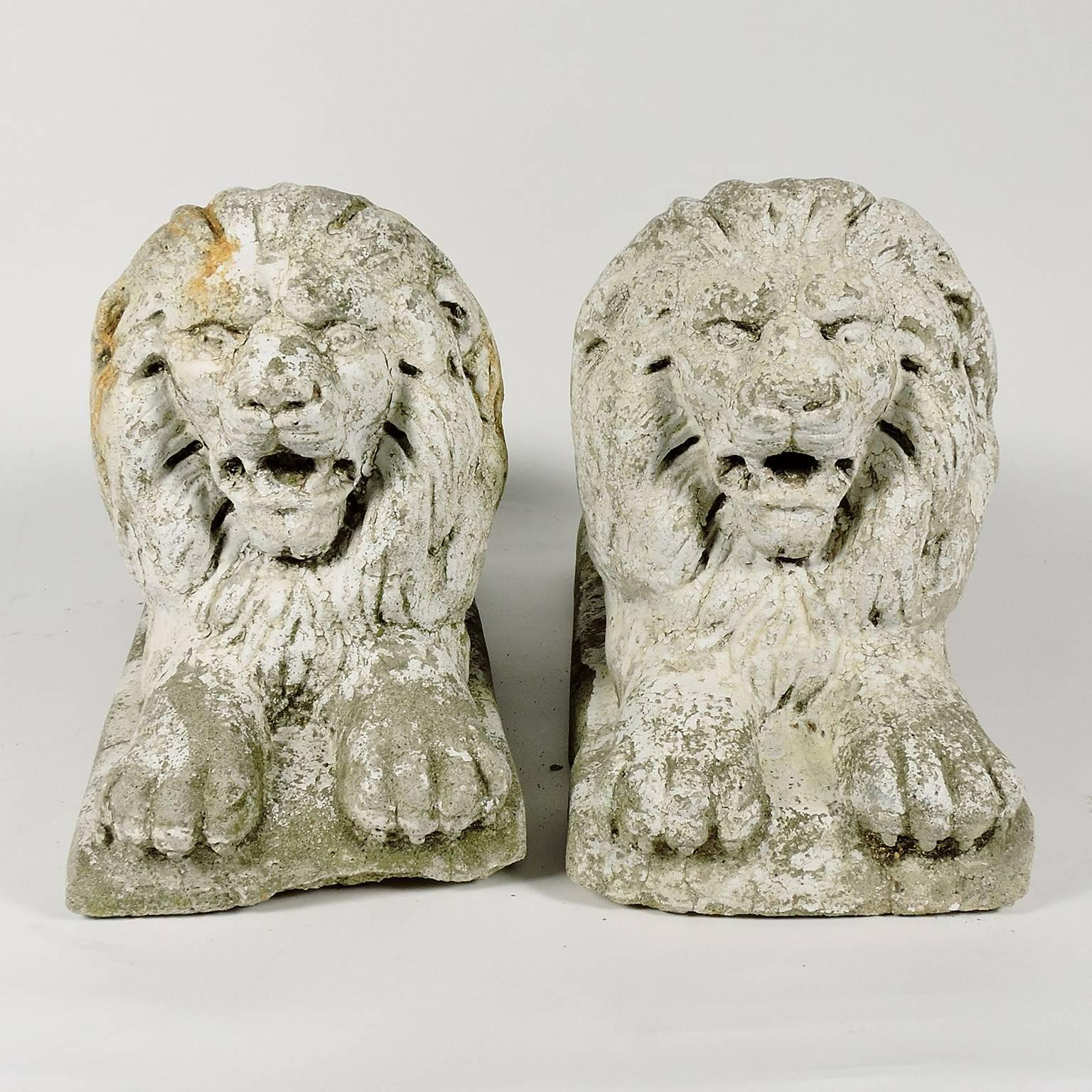 Pair of white painted cast stone recumbent lions, circa 1920.
Measure: Height 10 1/4 in, length 16 1/4 in, width 7 in.