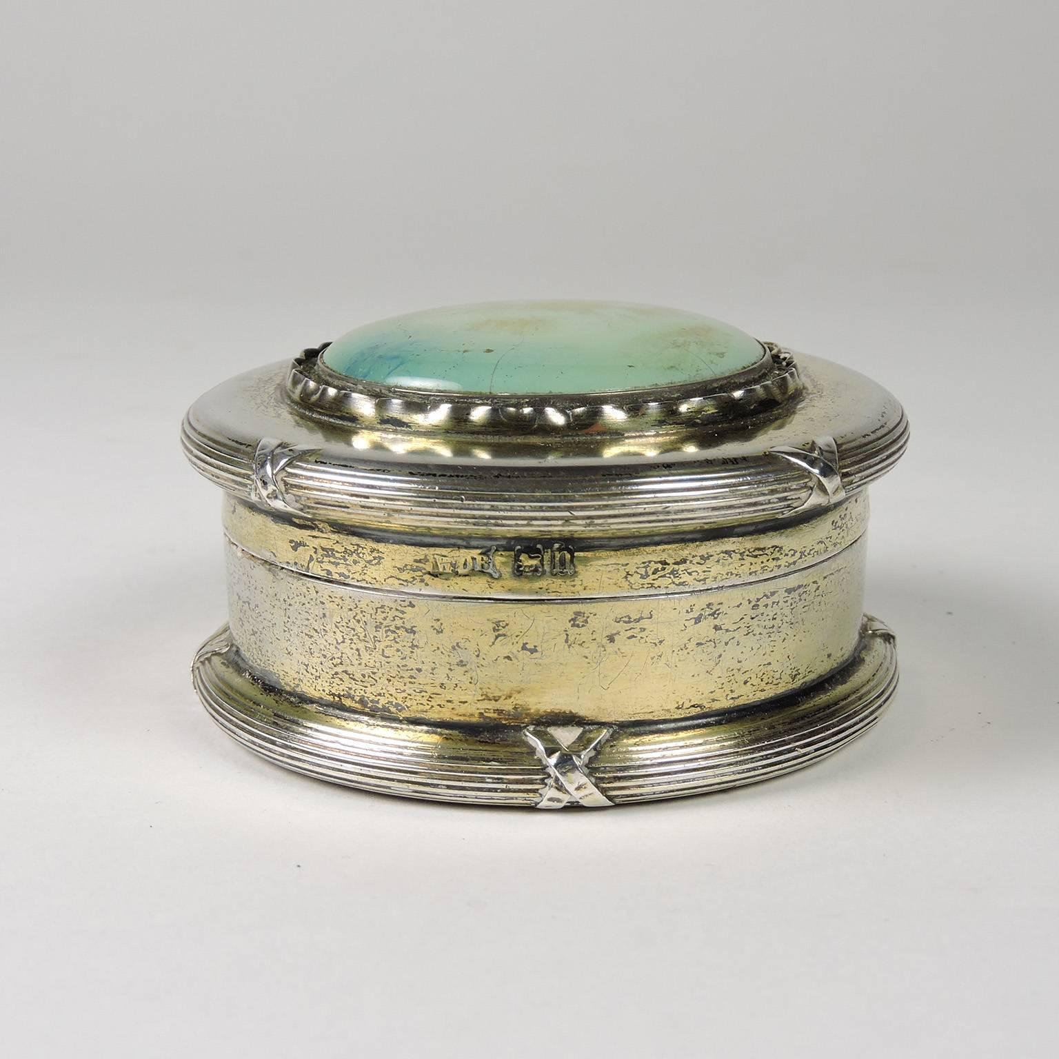 English Arts & Crafts period silver powder box with Persian turquoise medallion, William Disney Barlow, maker, Birmingham, circa 1912, bears lion passant mark and uncrowned lions head, WDB makers mark and date stamped N for 1912. Diameter: 3”,