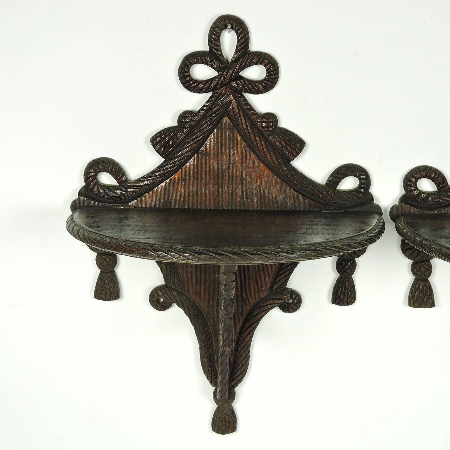 Pair of 19th century carved Mahogany Adams style wall brackets, with ribbon and tassel decorations, folding shelf, numbered 207 on verso.
Measure: Height 15 in., width 11 in., depth 6 1/2 in.