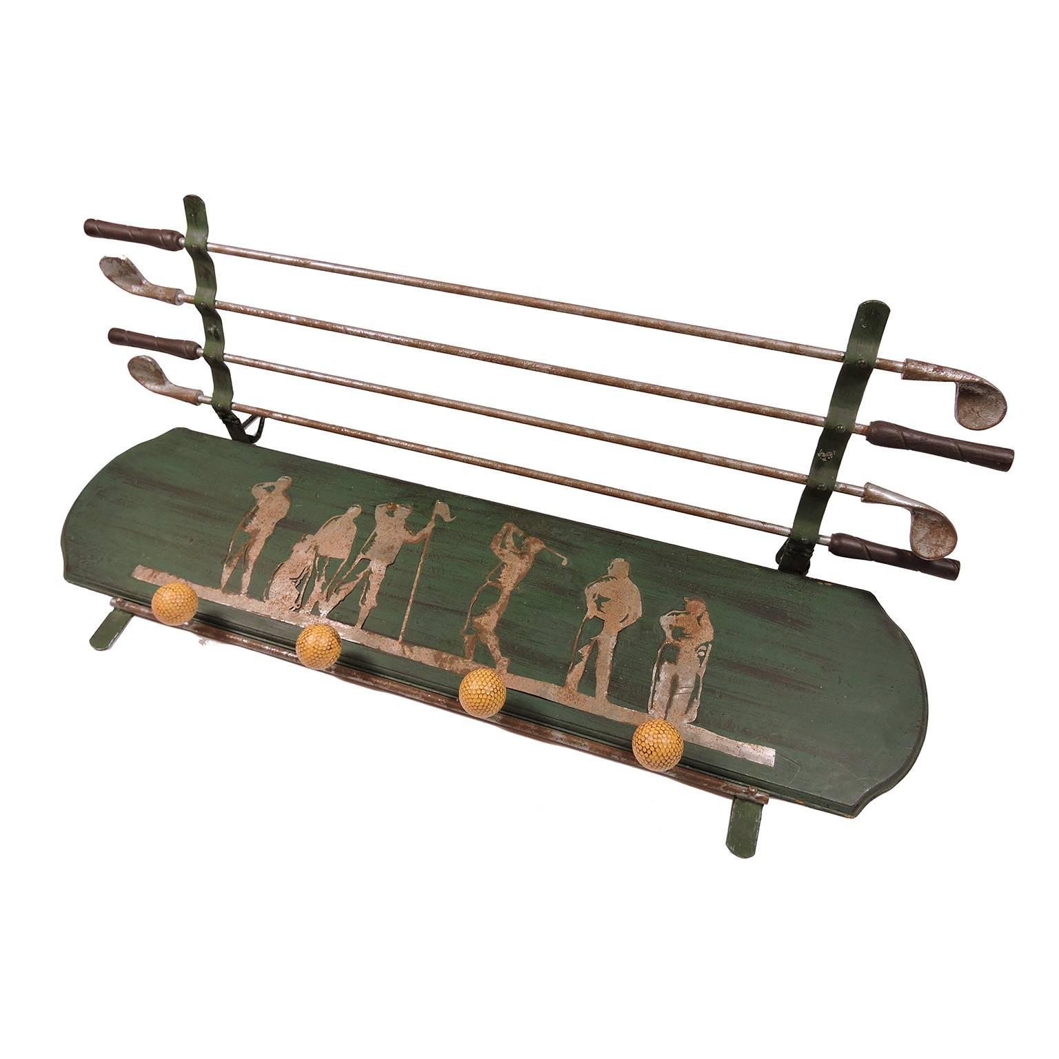 Unusual vintage green and silver painted Golfer's hanging wall coat rack, mid-20th century; comprised of silver painted Silhouette figures playing golf behind four horizontal golf clubs that lift up with four golf ball hooks below. Measures: