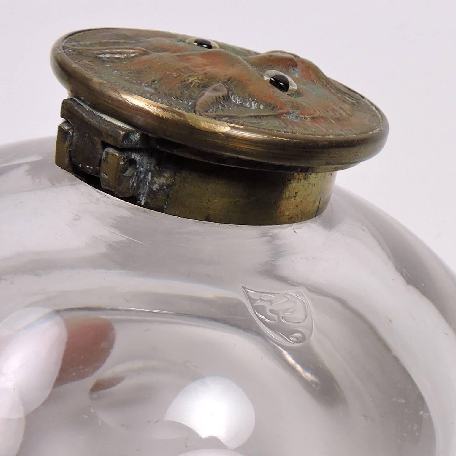 Whimsical Antique 19th Century Cat top Glass and Bronze Inkwell.  Cat with glass eyes, glass body of inkwell with impressed mark in sheild (illegible); Diameter: 4 3/8 inches; height: 2 1/4 inches