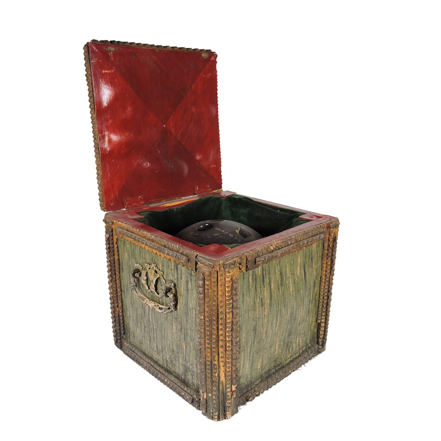 Unusual Tramp Art Box with fitted green velvet interior to hold a large bowling ball.  Sides comprised of marbelized paper and metal handles, with carved bowling pin decoration nailed to top over green velvent.  Constructed of pine with chip carved