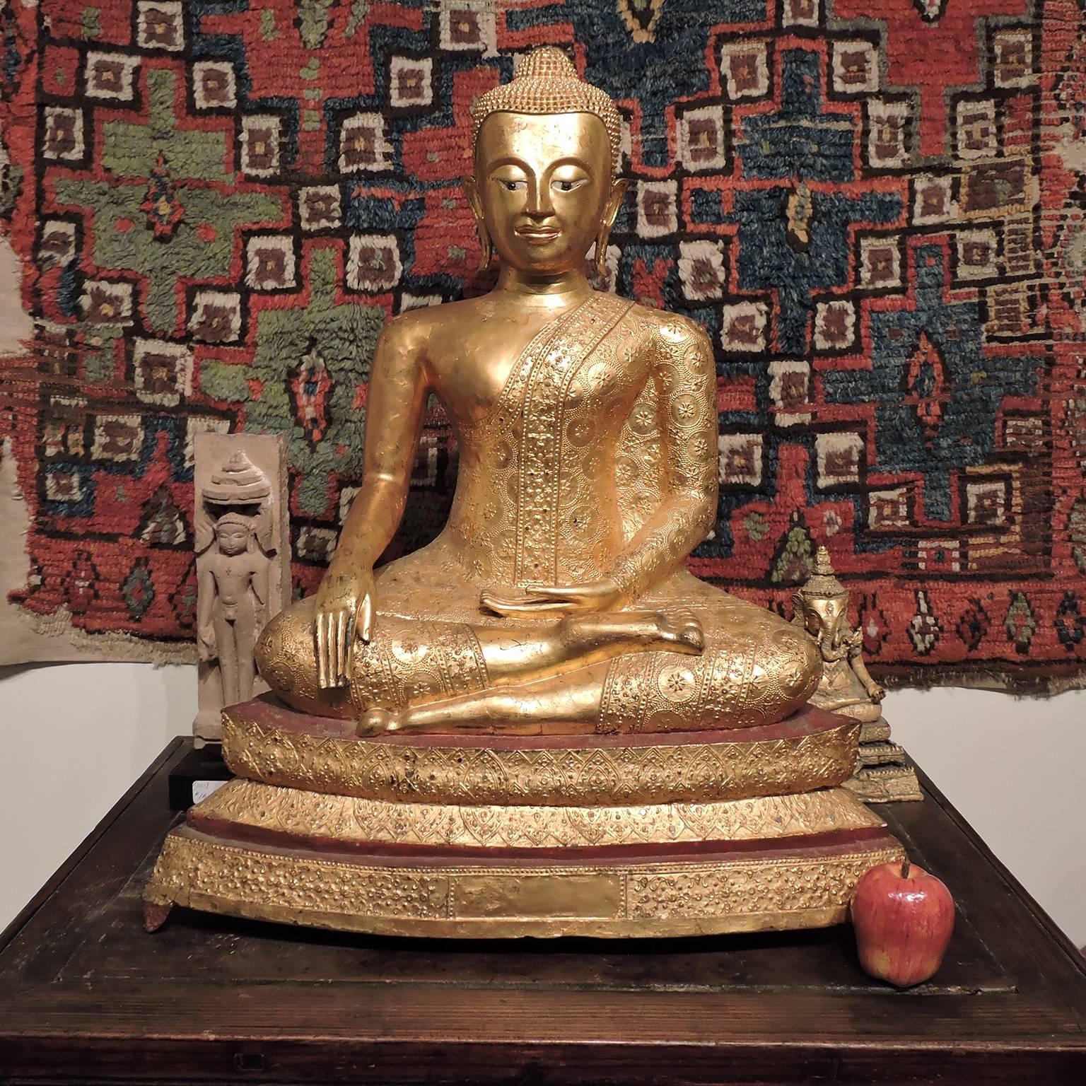 Large Rama IV Gilt Bronze Buddha, Thailand, 19th century; seated in touching the earth mudra on double lotus base; with reflective inlay and green gemstone eyes. From a very prominent American collection, full provenance available to