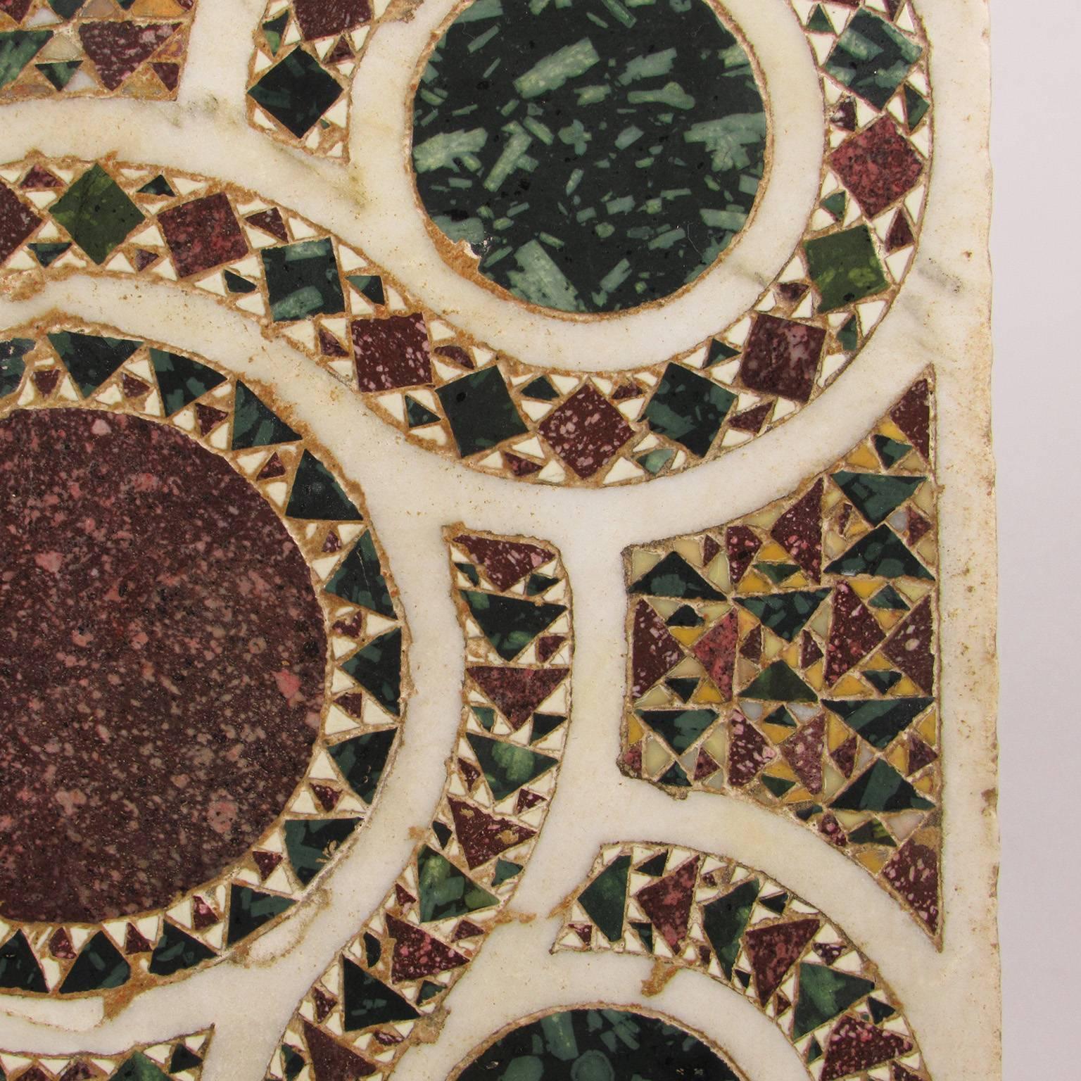 Italian Cosmatian Pietra Dura Specimen floor tile, 13-14th century, probably Rome; The square marble top with a chain of five interlacing circles inset with specimen marbles and stones. An almost identical piece was sold at Christies (made into a