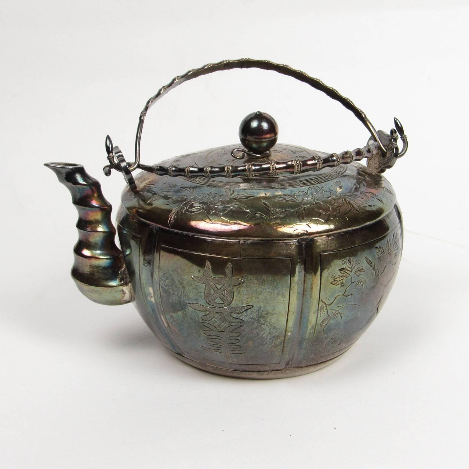 Signed Japanese silver calligraphic teapot, with three calligraphic panels and etched floral and bird design. Faux bamboo handles and spout, signed on bottom. Excellent provenance available to buyer.
Dimensions: 4 x 5 1/2 x 4 inches.