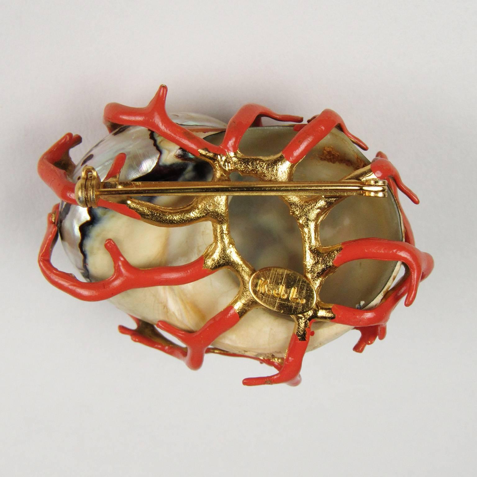 Vintage Kenneth Jay Lane faux coral shell form brooch, circa 1960s
comprised of a mother-of-pearl shell encrusted with faux coral, with gold filled setting, marked 