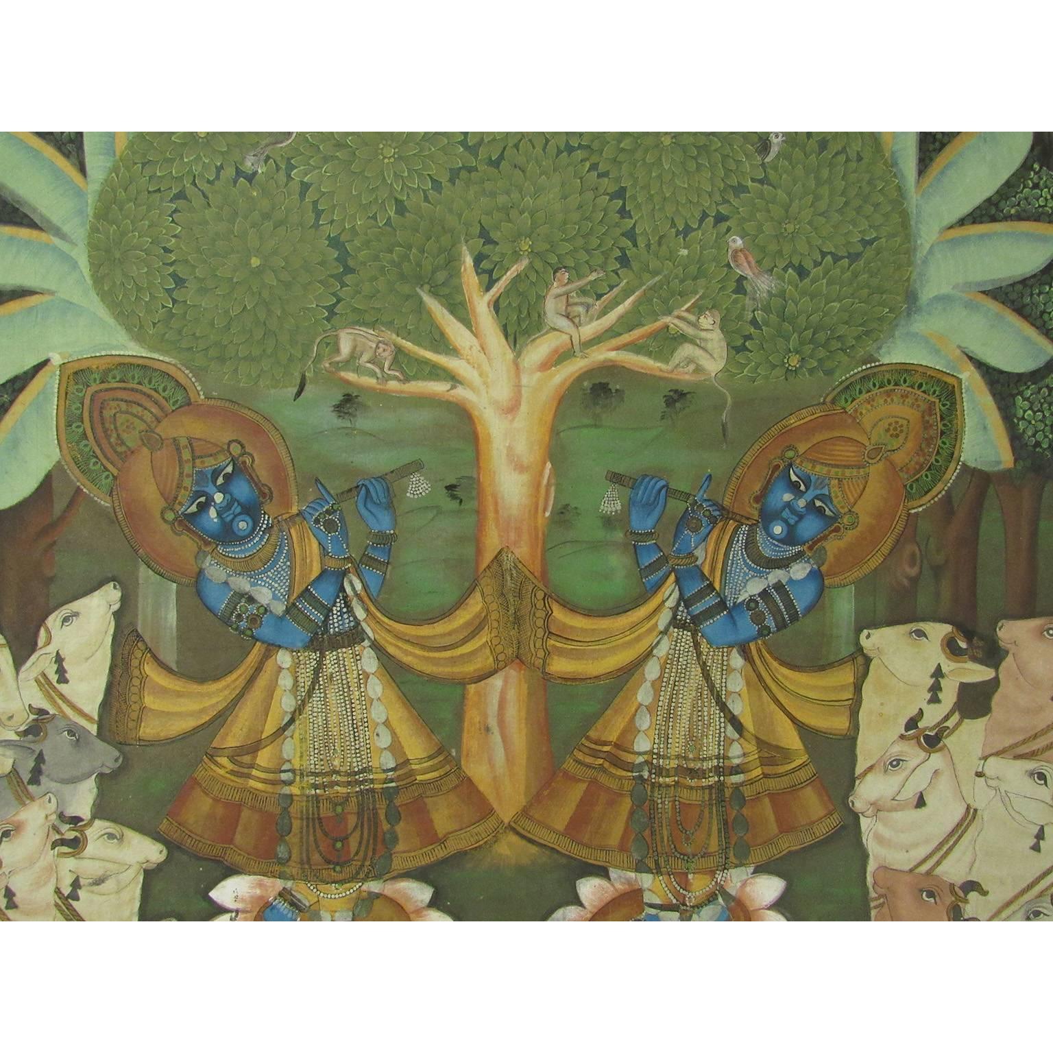Very good and large 19th century east Indian Pichwai painting; Rajasthan, India; tempera on canvas mounted on cloth; depicting two Krishna figures surrounded by two herds of white cows and a central tree of life, surrounded by a vine border with