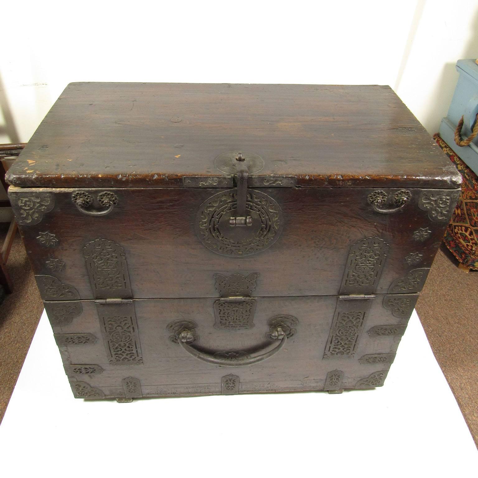 19th century Korean Hardwood Bandaji storage or blanket chest, with original iron mounts, drop front revealing a single shelf lined with calligraphic paper on both sides. Dimensions: 33 x 36 1/2 x 19 1/2 inches.