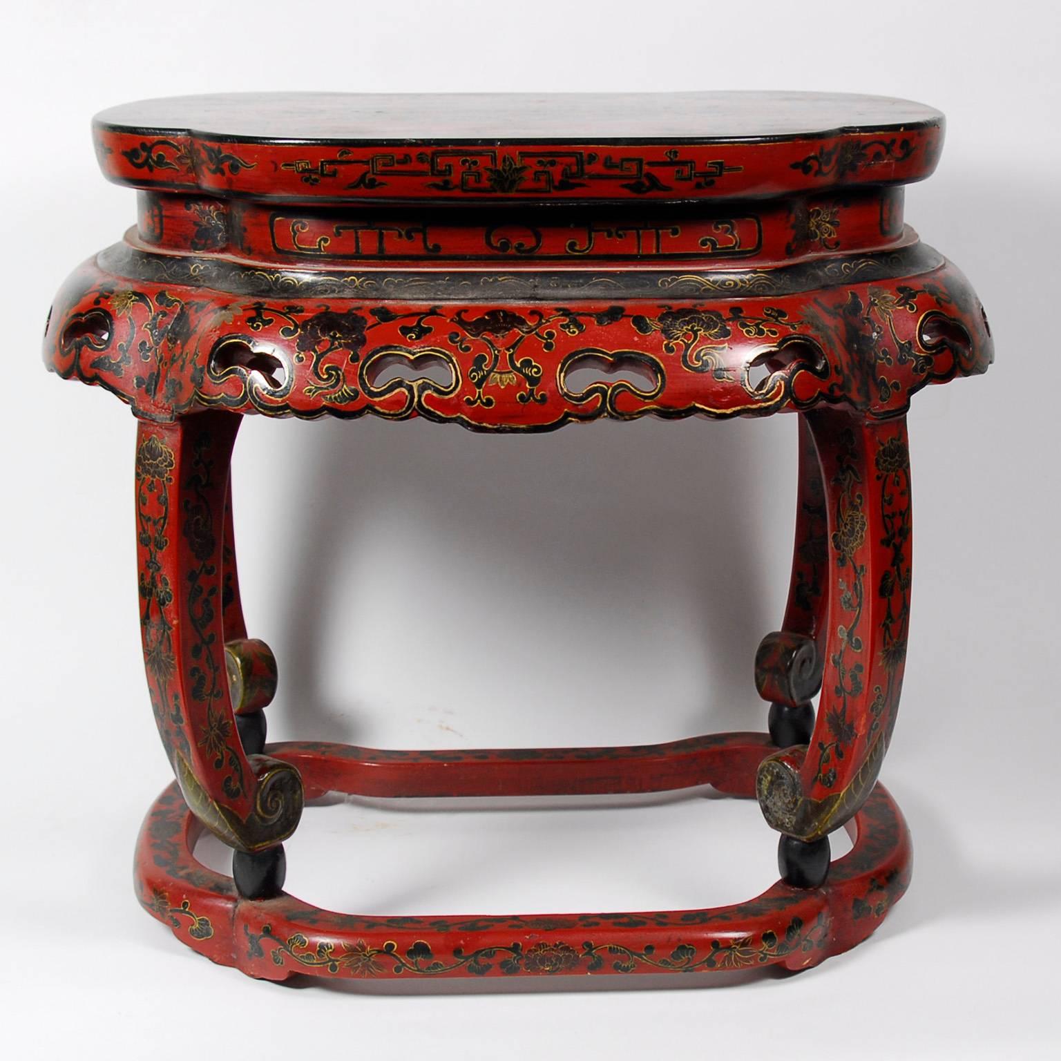Pair of late 19th to early 20th Century Chinese Red and Black Lacquer Side Tables, each with pierced aprons and floral decoration, raised on curved legs ending in scroll feet. Dimensions: 20 1/2 x 23 x 16 inches
