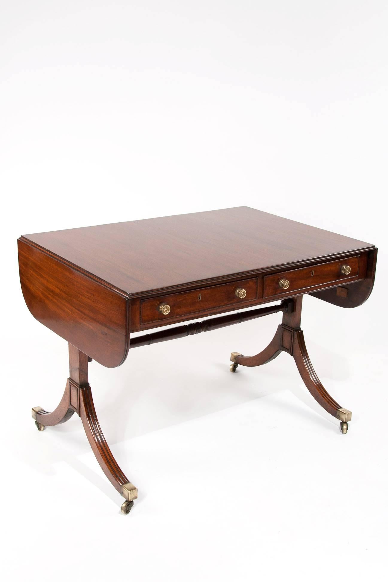 A very elegant Regency mahogany two drawers sofa table. Of very Fine proportions this quality mahogany sofa table has a solid rectangular top with a reeded edge and two drop flaps which extend to make the table length 58 inches / 147.5cm overall,
