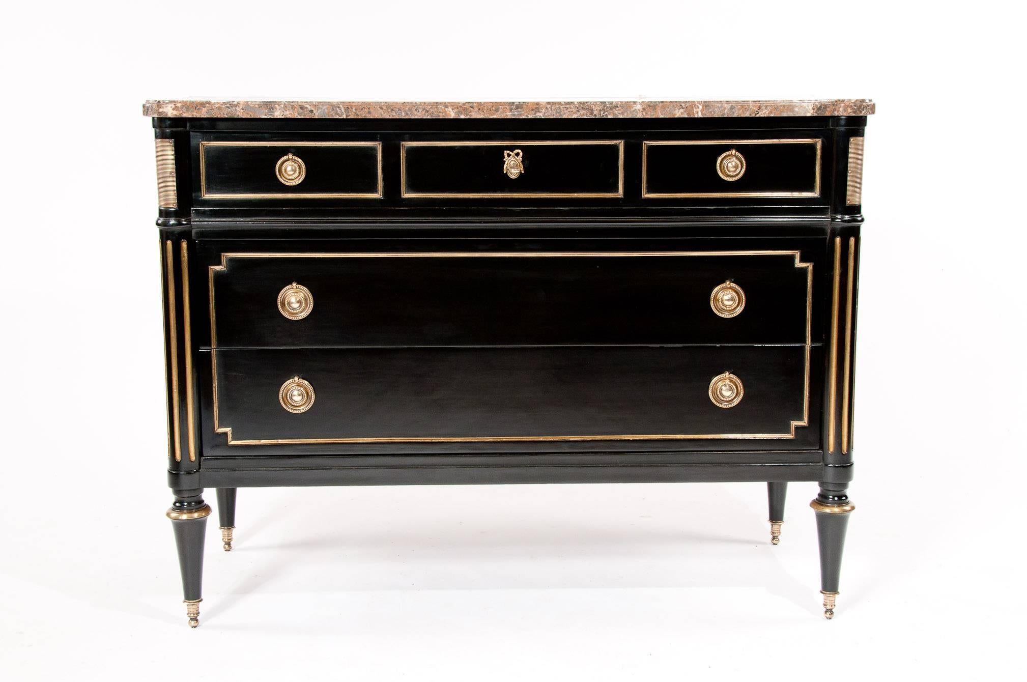 An extremely fine quality ebonised French marble topped and brass inlaid commode in the Directoire style and manner of Maison Jansen. 
Dating to circa 1930 this very fine quality commode has a shaped and moulded marble top over a brass panelled