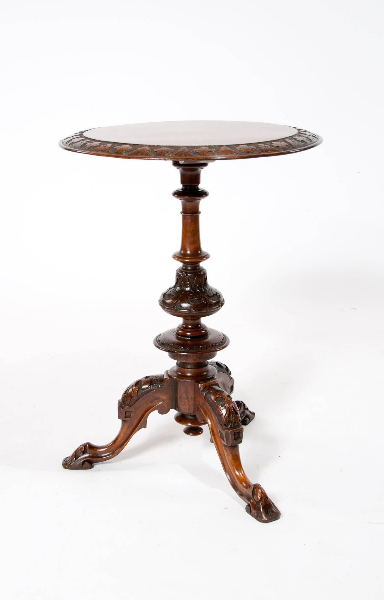 A very good quality and well carved Victorian inlaid walnut tripod occasional/wine table with Irish carved edge. 
The circular burr walnut top having a boxwood inlaid knight on horseback slaying a dragon with an Irish carved pierced edge above a