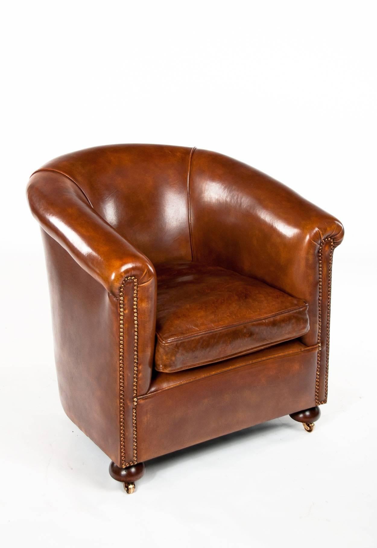 A Quality antique leather upholstered tub armchair. 
This leather upholstered tub armchair dating to circa 1920's has a rounded back with shaped arms and brass nailed studding. The leather chair being tub shaped is always a rarer and harder to find