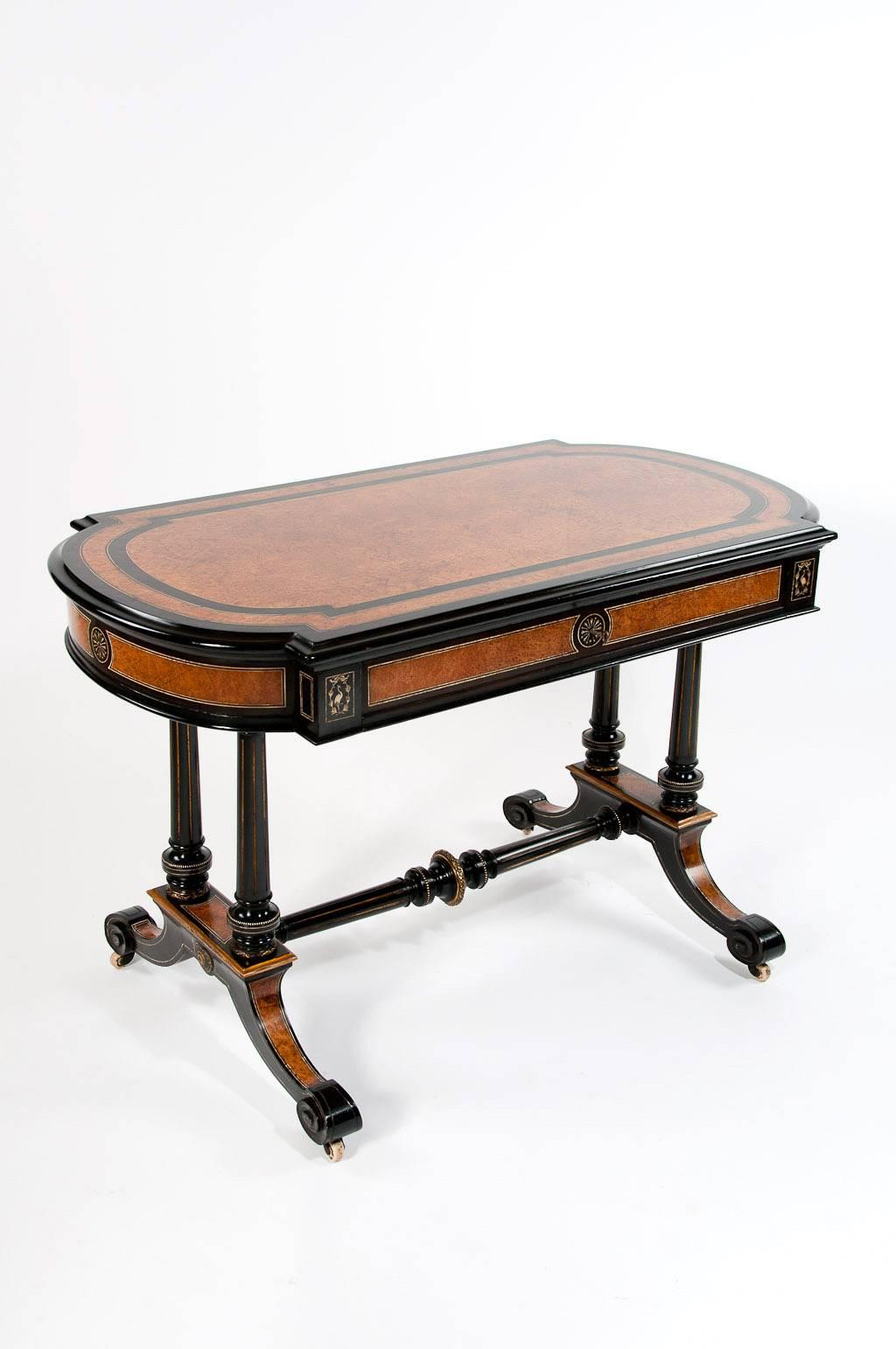 A superb quality mid-19th century library stretcher table in ebony and amboyna. This lovely quality table has been constructed in the manner of Gillows of Lancaster being one of Englands best known furniture makers, often their goods were not