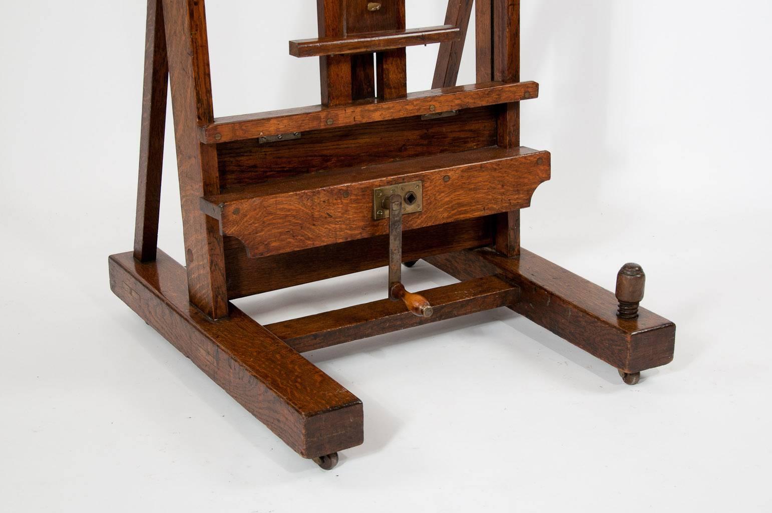 A fantastic quality large oak studio easel by the famous firm Winsor and Newton from London. In lovely condition this large adjustable oak easel has it's original winding handle and makers plate inset 
