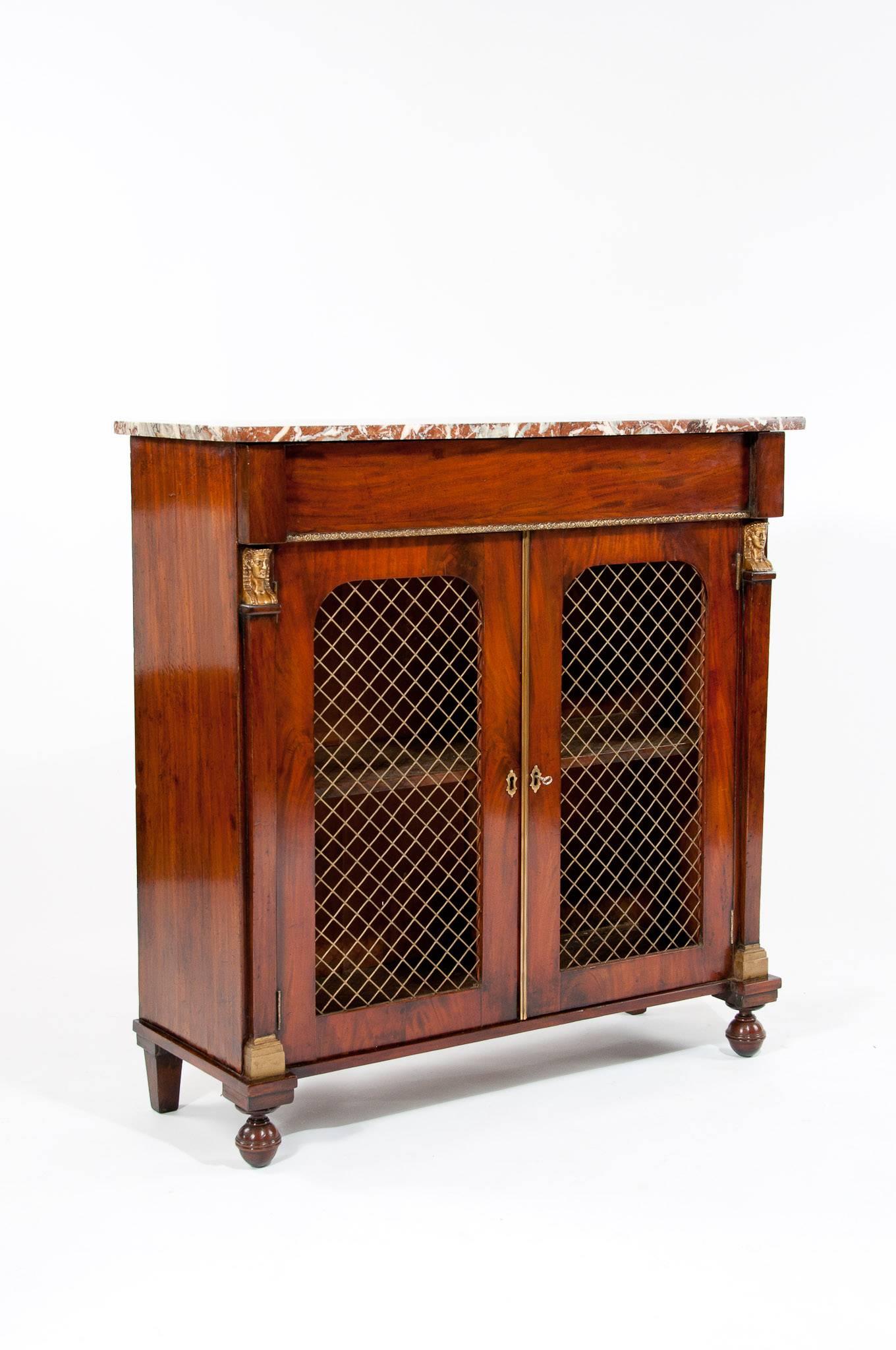 A quality Regency marble topped mahogany two door chiffonier / side cabinet of very good proportions being three feet wide. This antique chiffonier / side cabinet dating from the Regency period has a rectangular marble top sitting over a frieze