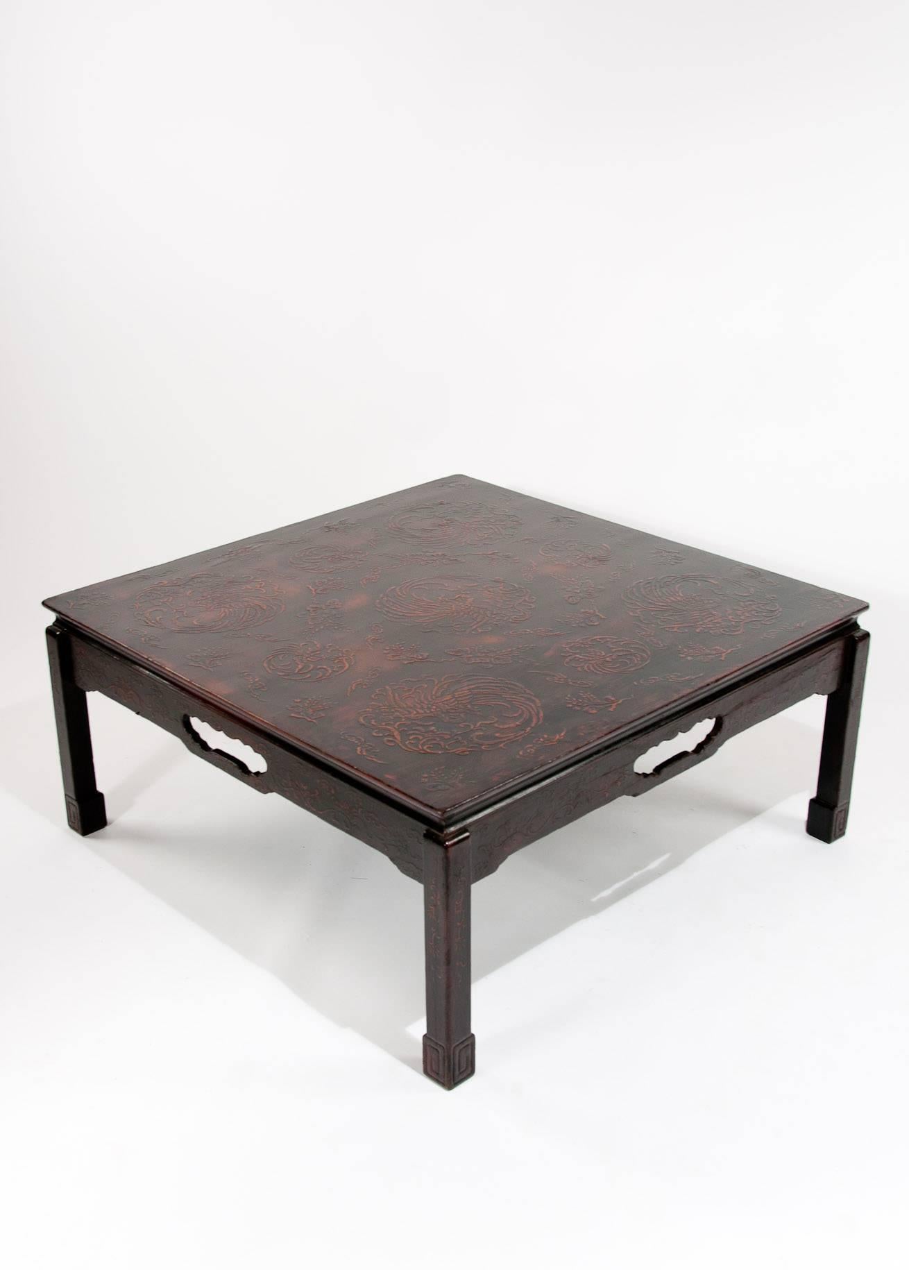 A well proportioned Chinese raised lacquered Mid 20th century coffee table. With a square decorative raised lacquered top sitting over a shaped frieze with a central fretted opening supported by four square cut legs with box foot. 
In very good