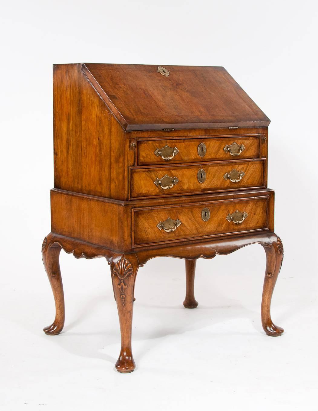 A very good quality walnut bureau on stand raised on cabriole legs with shell on the knee.
Dating to circa 1880-1900 this walnut bureau has been constructed in the same manner as a Queen Anne bureau and the attention to detail is excellent. It's