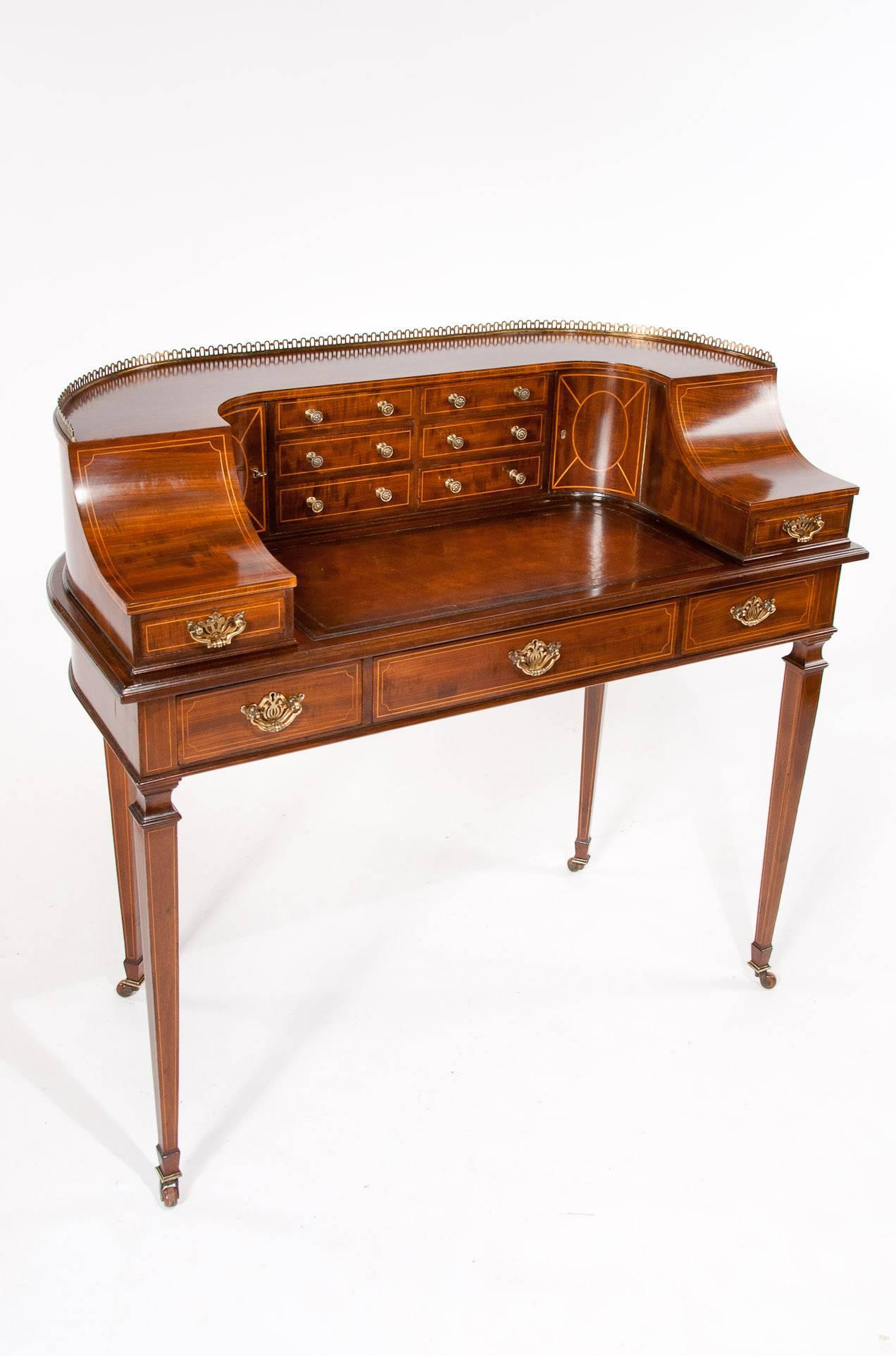 A fine quality late 19th century mahogany Carlton House desk having a extremely good choice of mahogany used, often referred to as fiddleback mahogany. 

The brass gallery shaped back having an arrangement of drawers in the centre with a pair of