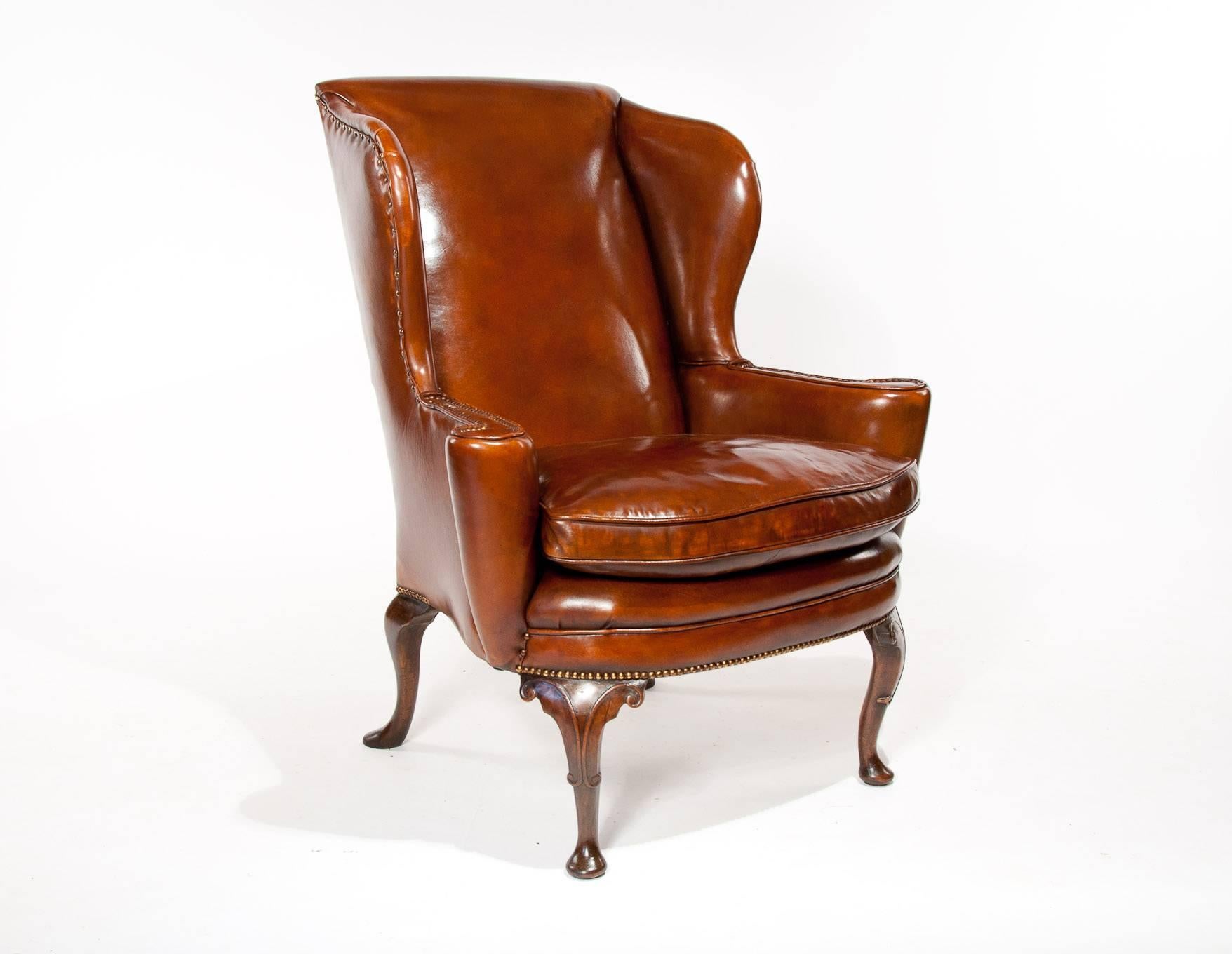 Superb quality antique walnut leather upholstered wing chair, mid-19th century having wonderful proportions. This fine quality antique leather wing chair has a very elegant shape with great proportions having an imposing size and a feather cushion