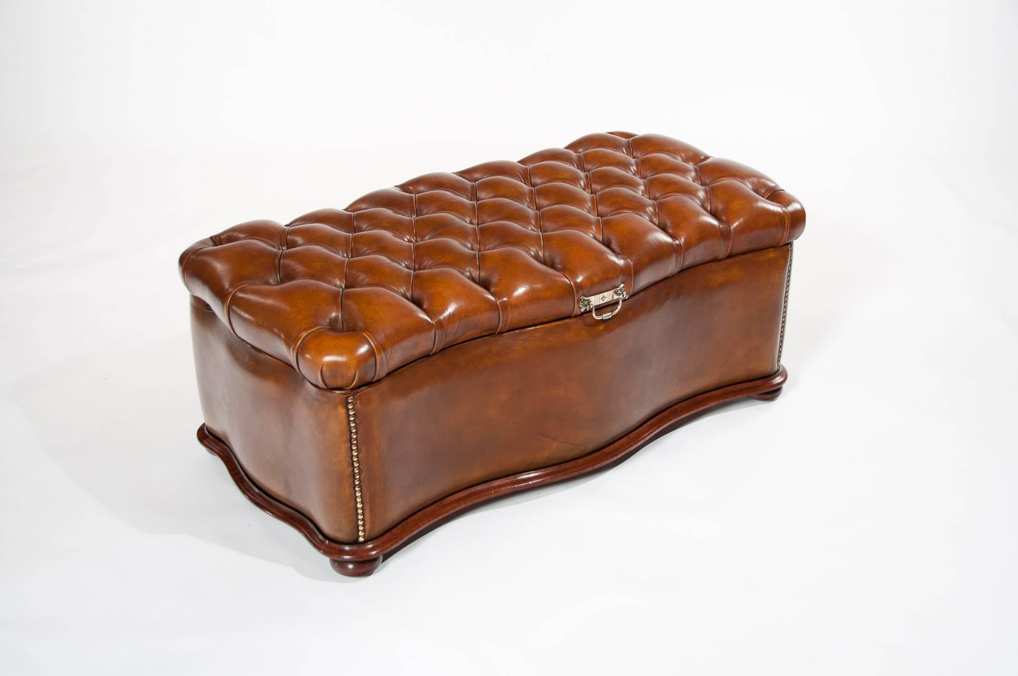 A very good quality mahogany mid-19th century, circa 1860 shaped leather upholstered deep buttoned ottoman.
The leather deep buttoned serpentine shaped top having a brass engraved plate handle which has the initials "J and D" stamped to