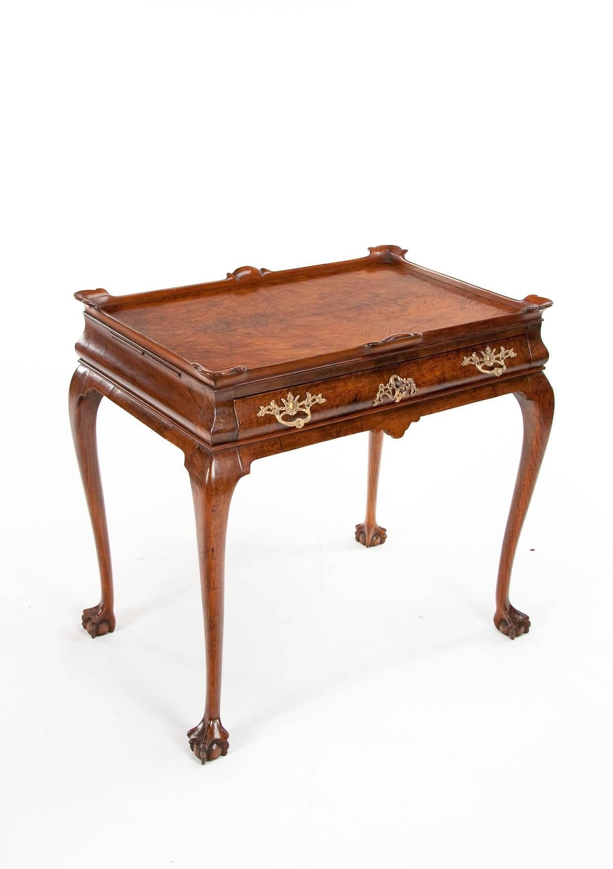 A good quality 19th century Victorian Dutch walnut silver table circa 1870. 
This finely veneered burr walnut silver table has a quarter veneered top with shaped upstand above a cushion shaped frieze with single oak lined and hand cut dovetailed