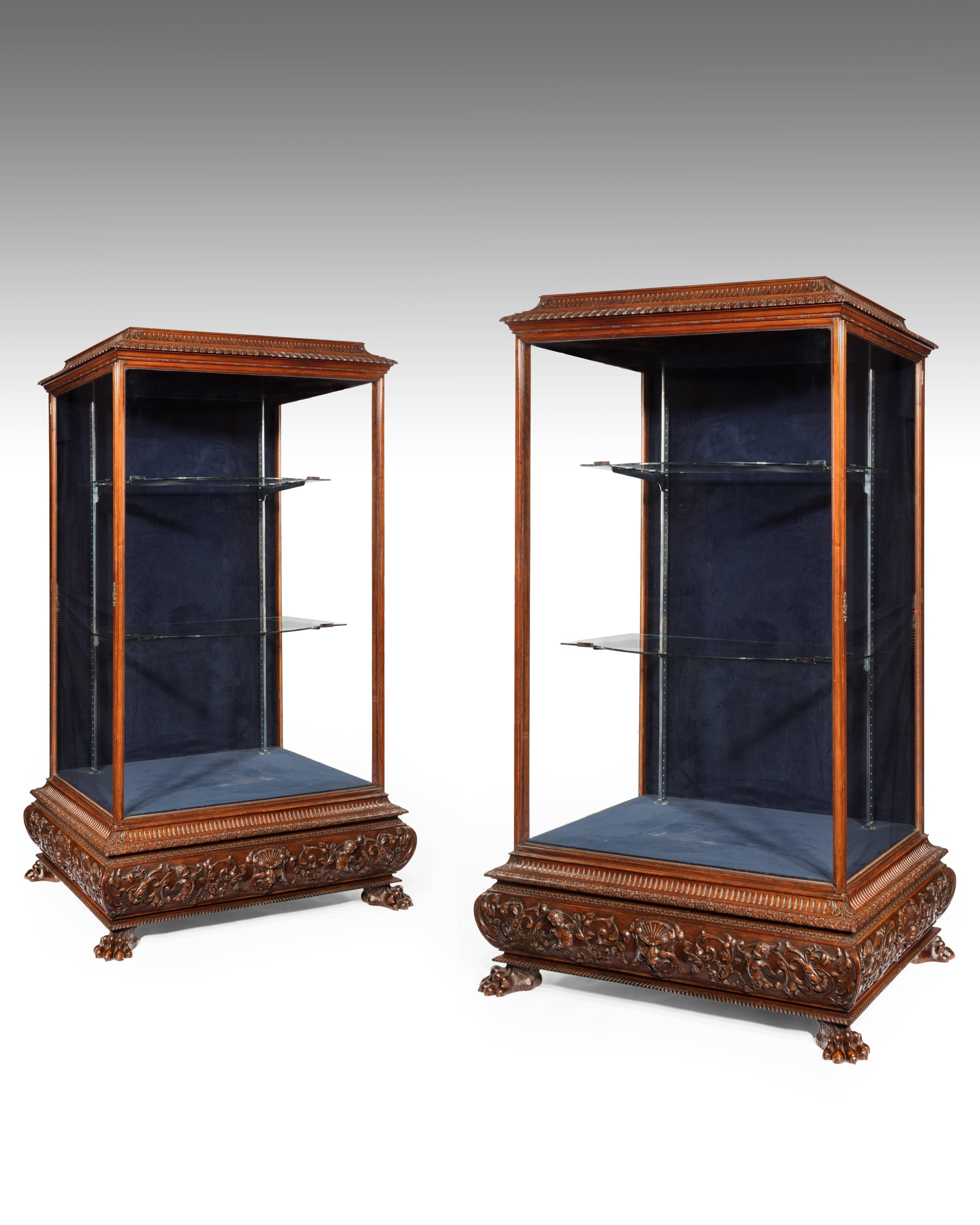 A Magnificent pair of large 19th century walnut display trophy cabinets, circa 1860.
This wonderful and extremely rare pair of cabinets are of large proportions being almost 7ft high. 
The carved and fluted pagoda tops sit above three glazed
