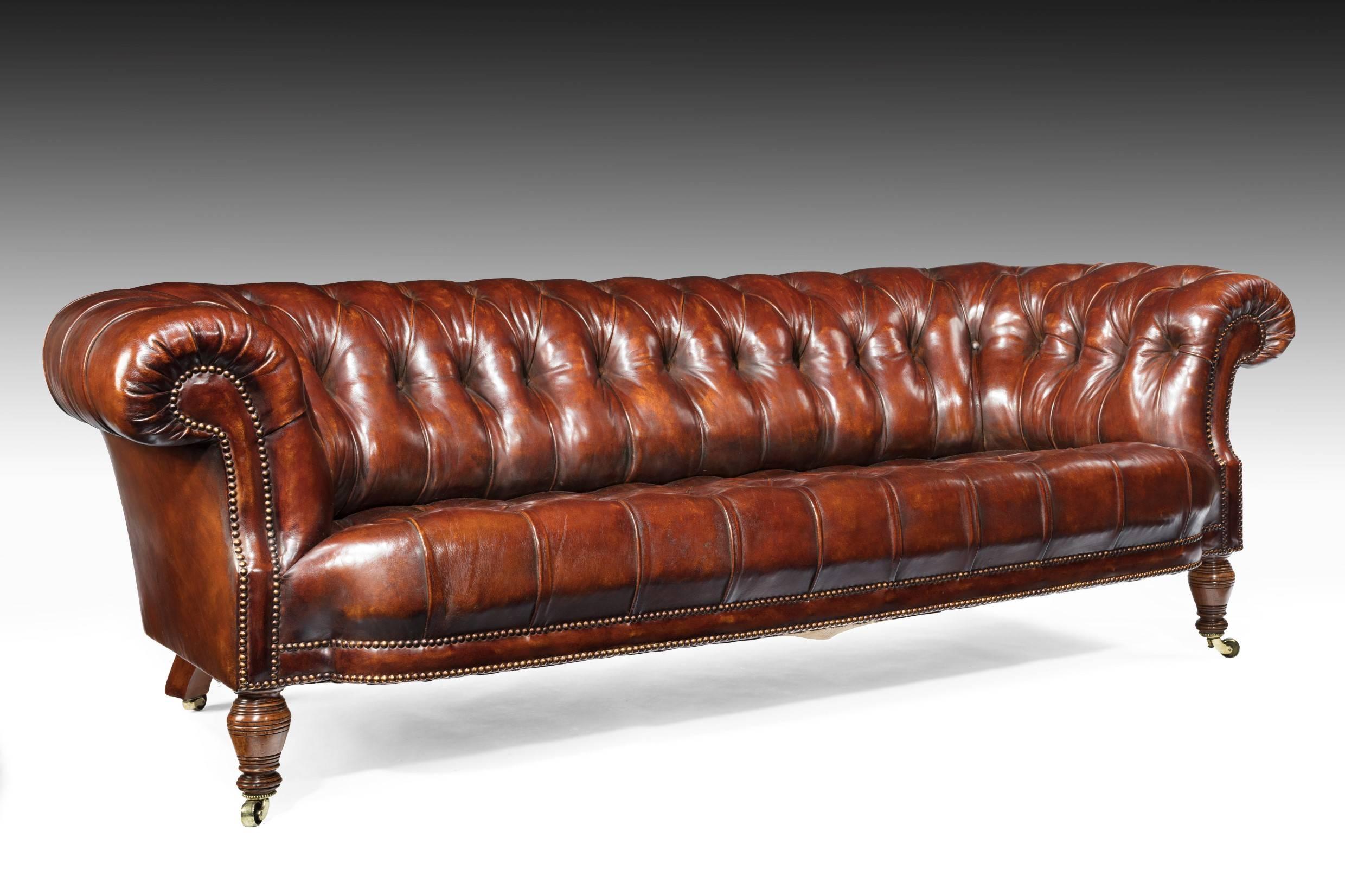 An extremely well drawn 19th century figured walnut deep buttoned leather upholstered Chesterfield stamped by the famous makers Holland and Sons who made furniture for aristocrats and Royalty.
Having a shaped breakfront edge and scrolling arms this