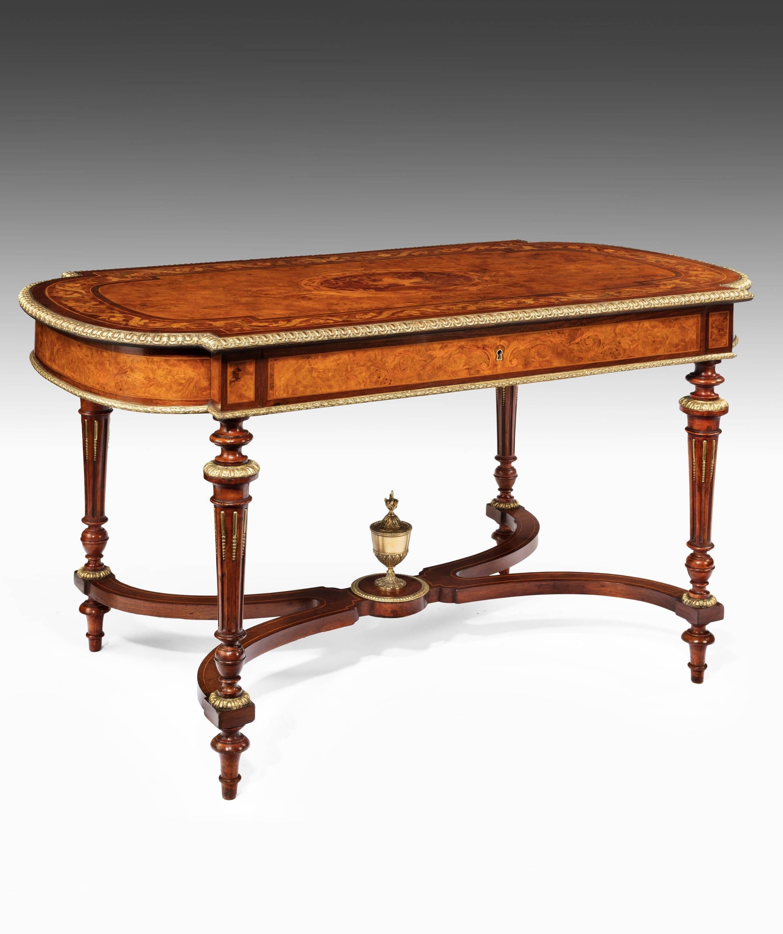 An exceptional quality burr walnut Victorian ormolu-mounted centre / writing / library table in the manner of Holland and Sons with exotic wood marquetry inlay of large proportions.
This is a very rare table to find with the marquetry and ormolu