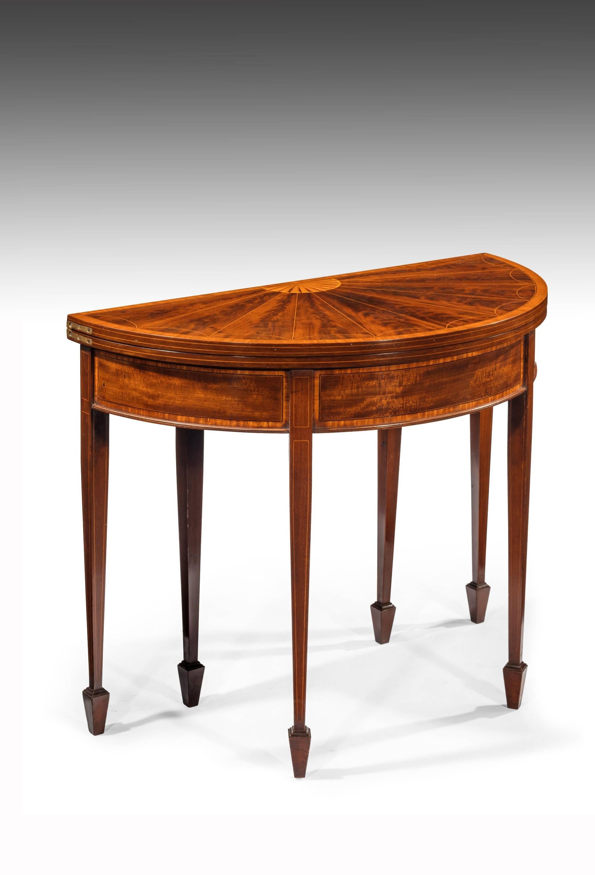 A very fine 19th century mahogany six legged demilune card table with sunburst inlaid top. 
This extremely good quality fold over card table of demilune form dating to the late 19th century, circa 1880 has a beautifully segmented flame veneered and