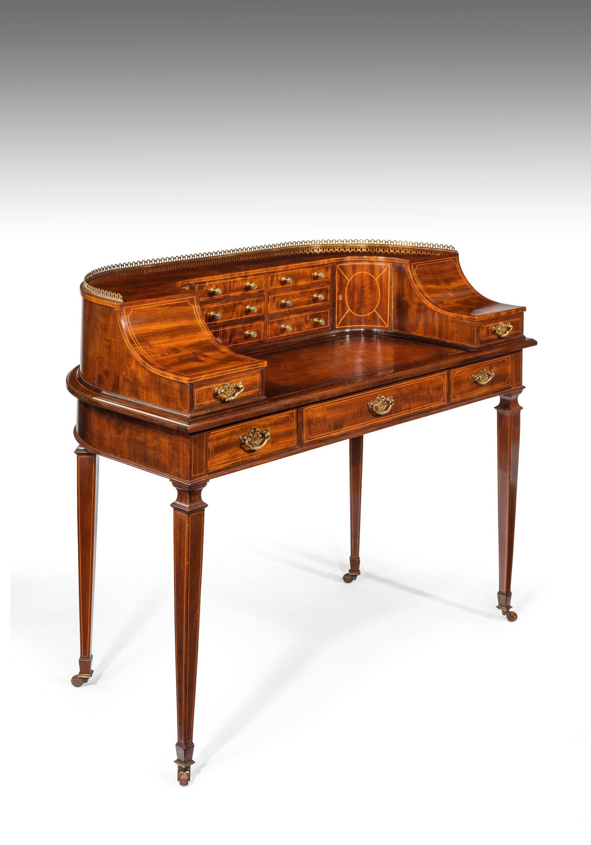 A fine quality late 19th century mahogany Carlton House desk having a extremely good choice of mahogany used, often referred to as fiddleback mahogany. 
The brass gallery shaped back having an arrangement of drawers in the centre with a pair of