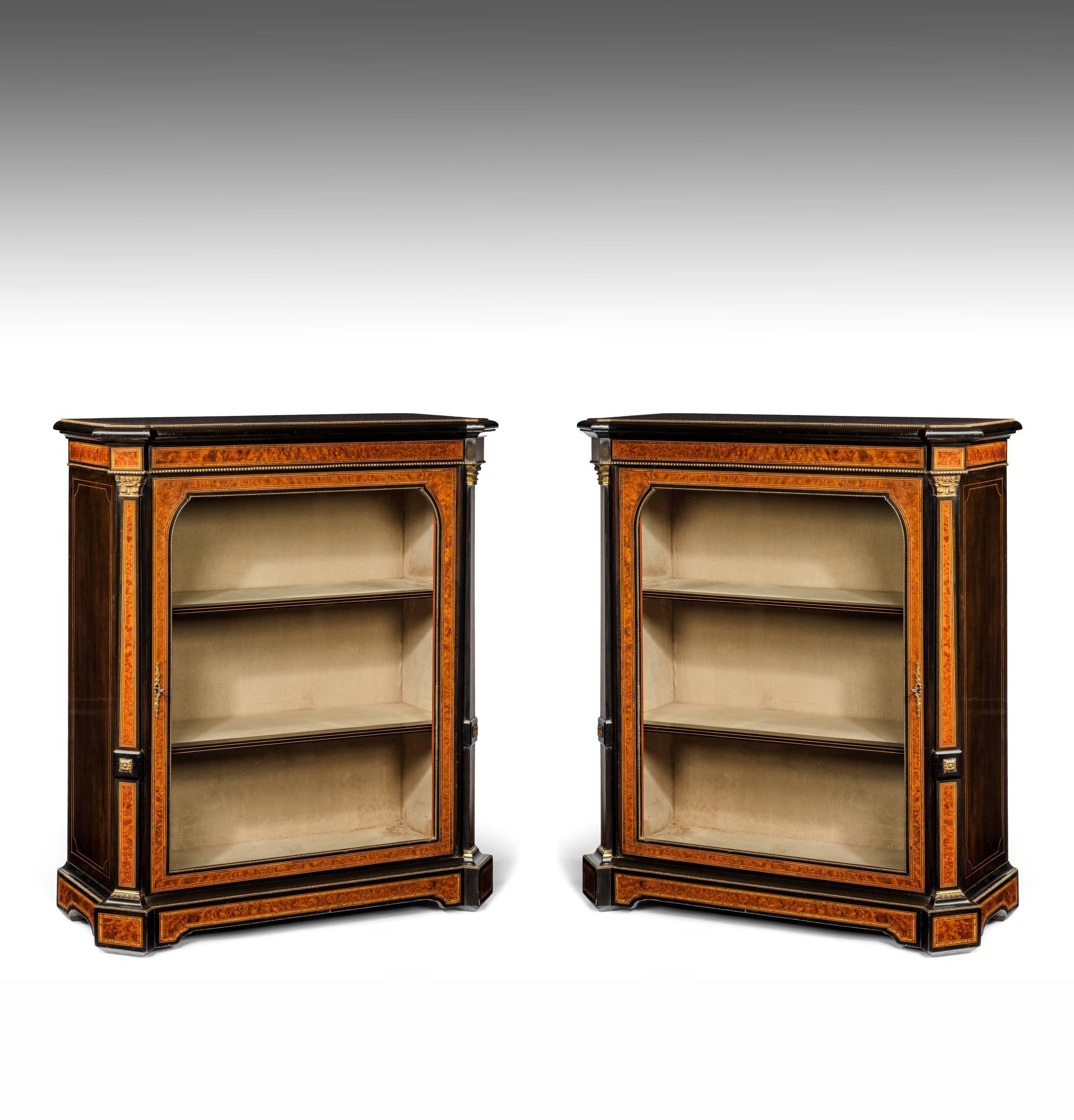 A delightful pair of ebonised amboyna and pollard oak inlaid pier cabinets dating to 1860. 

This pair of cabinets are of the highest quality being finely inlaid and banded with amboyna, pollard oak with boxwood. 
Please also bear in mind that