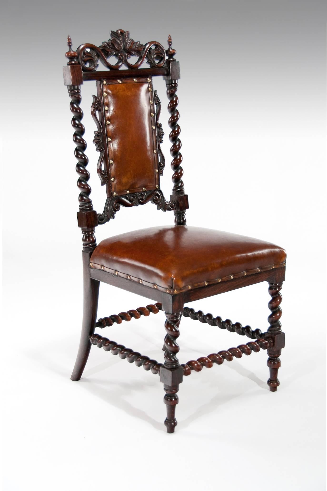 Good quality Victorian solid rosewood side chair upholstered in leather. 
This attractive side chair has a pierced carved foliate scrolling top rail supported by barley twist columns and a padded leather and carved back. 
The hand dyed leather