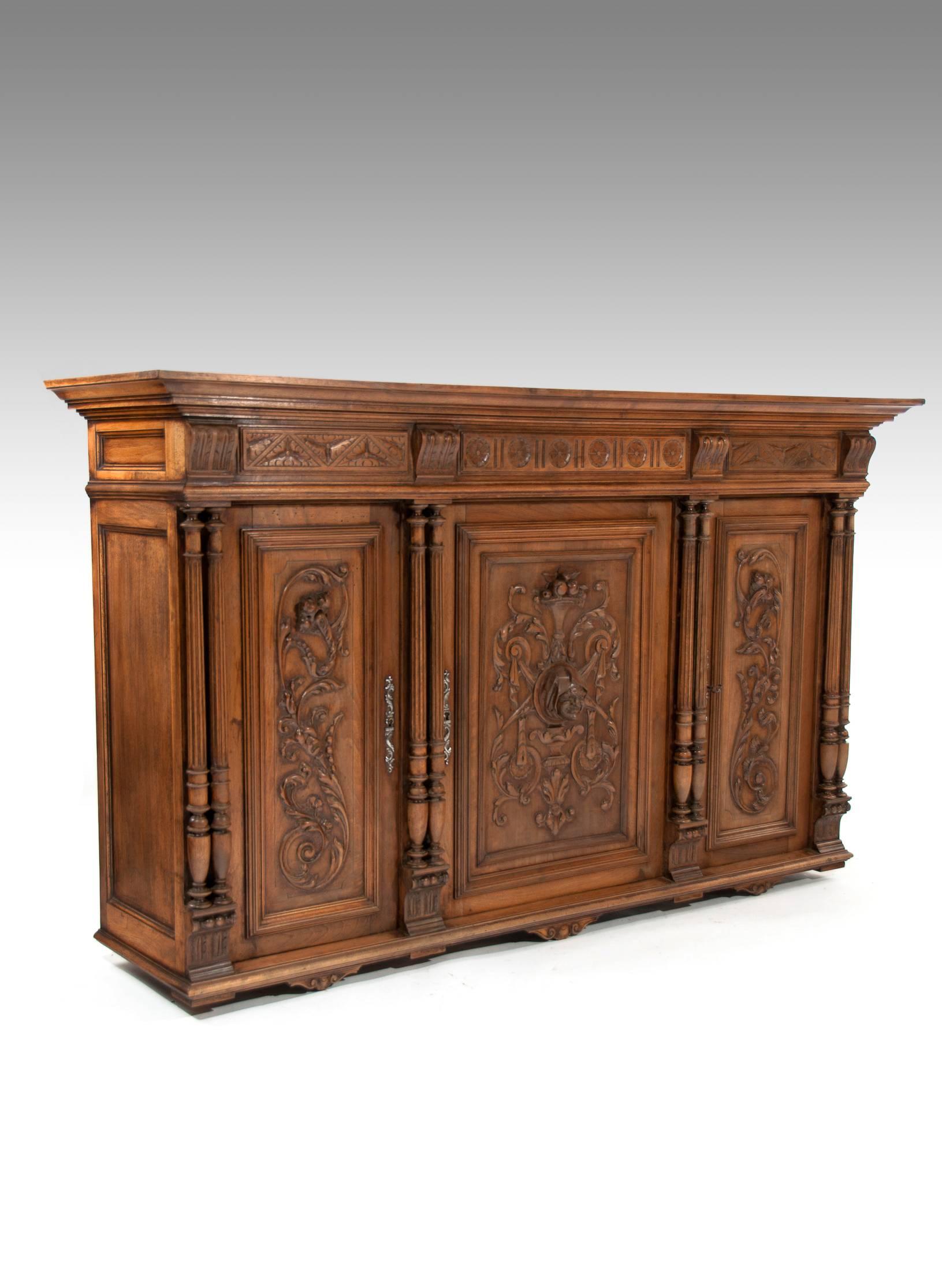 A 19th century European carved hanging three-door Renaissance Revival cabinet, circa 1870.
Of an extremely high standard of carving having an unusual protruding rural villager pointing outward from the middle door (with wart to the chin!) this