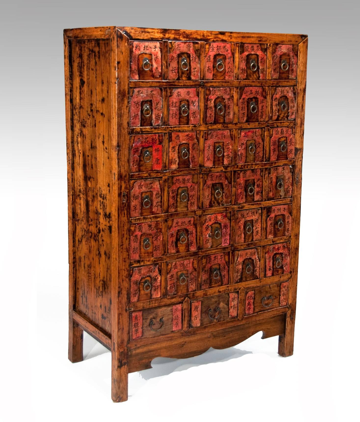 This very ornate medicine chest in red lacquer has its original finish, including the drawer labels and brass handles.
Once used by an apothecary to hold the herbs and remedies used in Chinese medicine, it is a lovely example of this type of piece