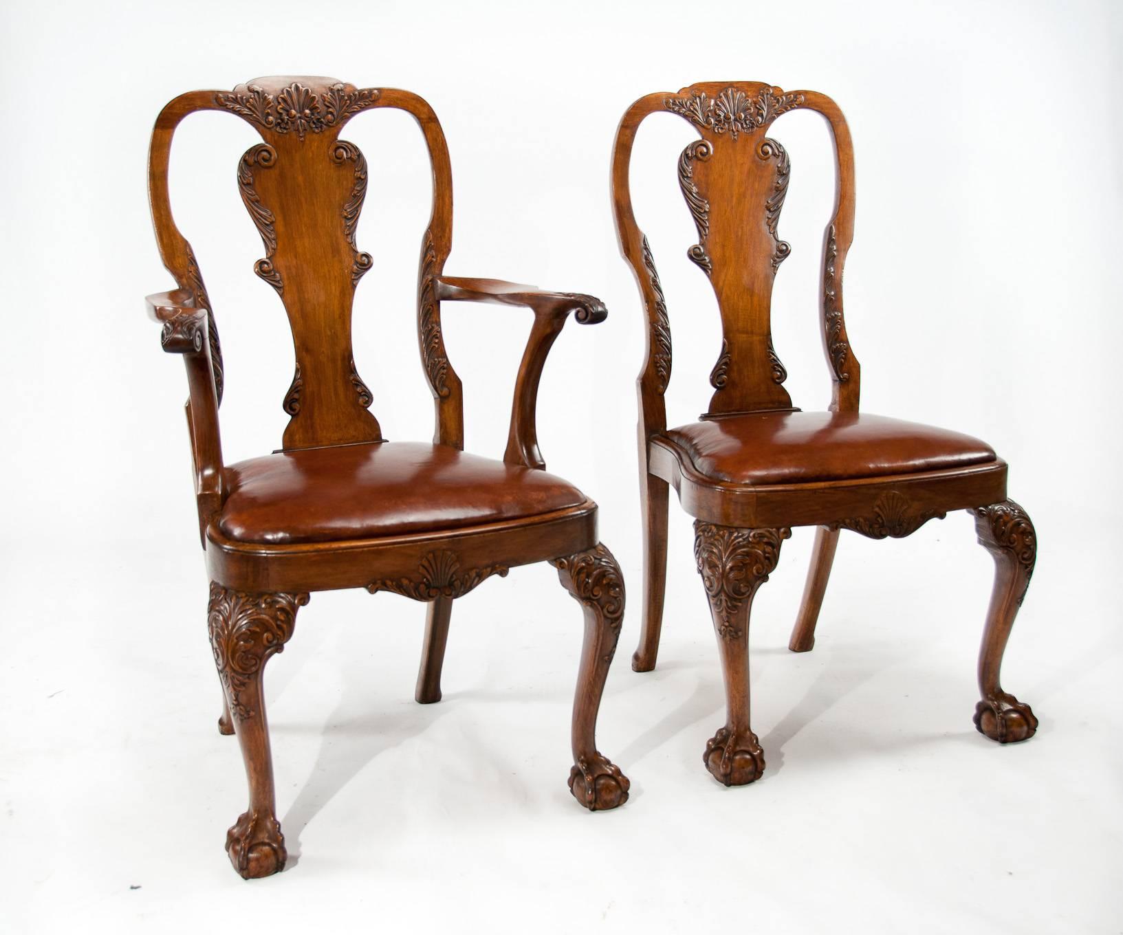Very good quality and rare set of 12 (ten + two) antique walnut dining chairs with leather upholstered drop in seats dating to circa 1910s-1920s.
Constructed in a Queen Anne design this quality set of dining chairs comprise of ten single chairs