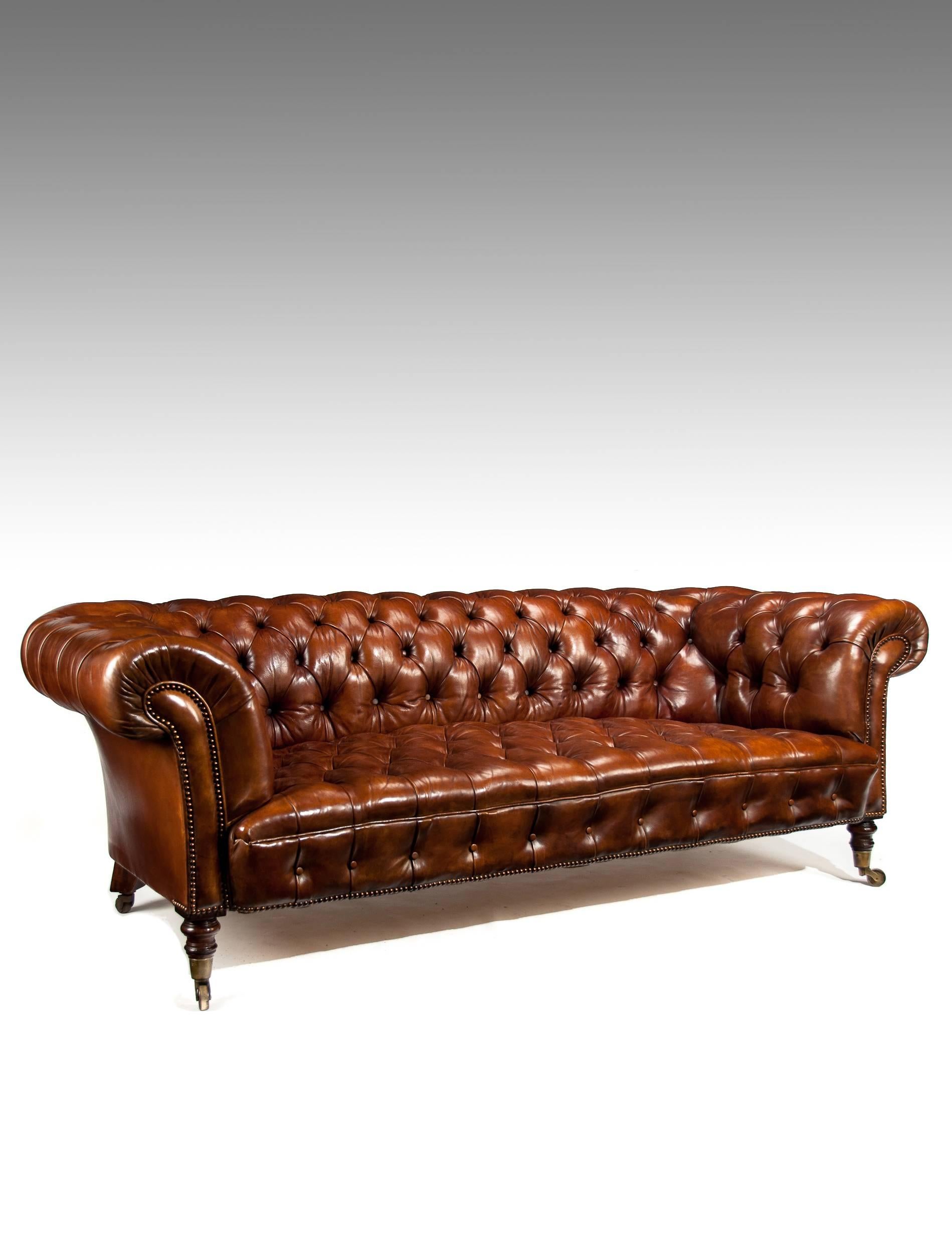 A very well drawn 19th century deep buttoned leather upholstered chesterfield on turned mahogany legs.
Having beautifully pronounced shaped scrolling arms and shaped breakfront edge this fine chesterfield has been recently upholstered in a very