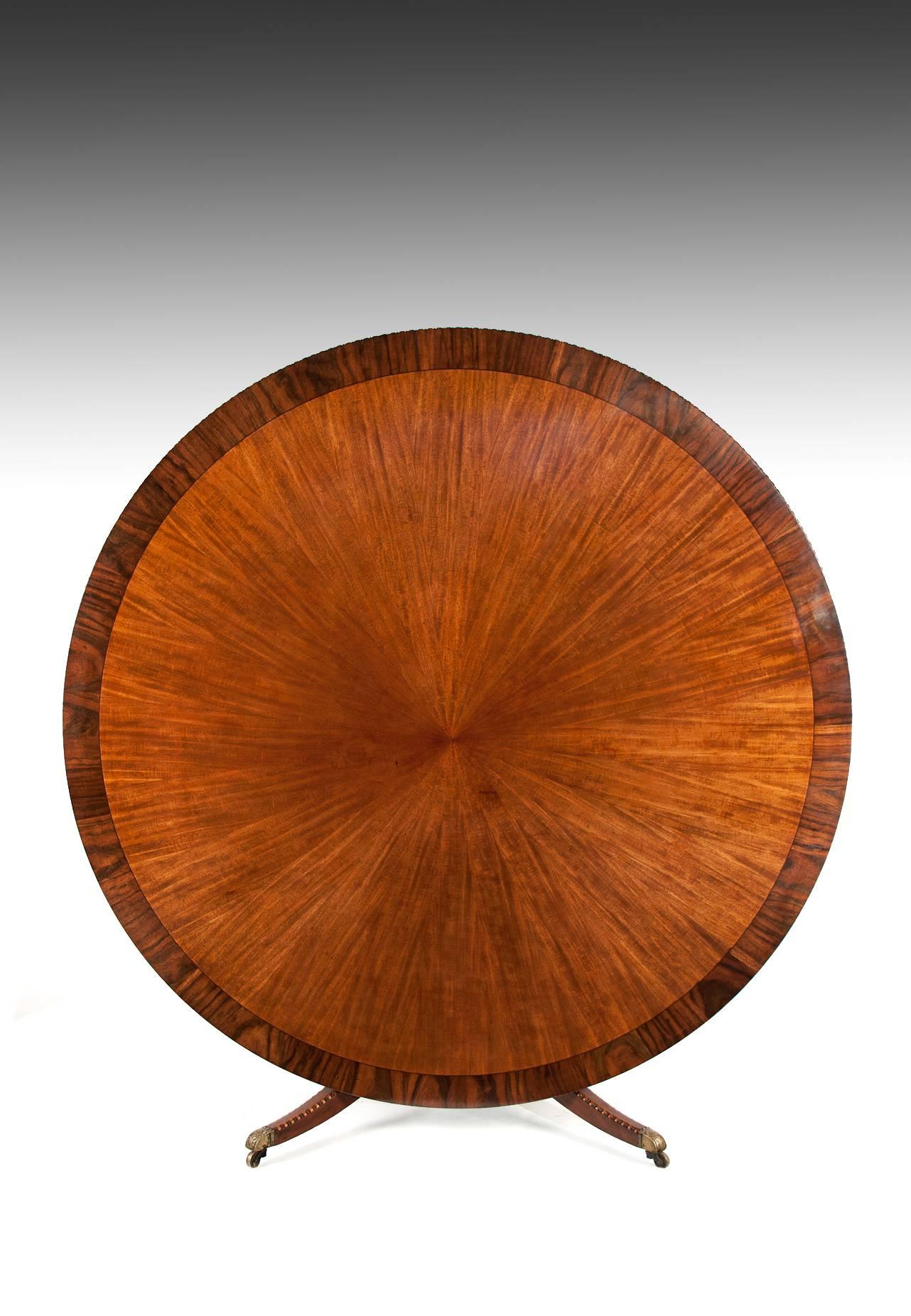 A very rare and extremely large 6 feet in diameter late Victorian tilt top sunburst mahogany dining table with ebony strung and coromandel banded edge, circa 1890.
This stunning antique circular dining table is extremely rare being 6 feet in
