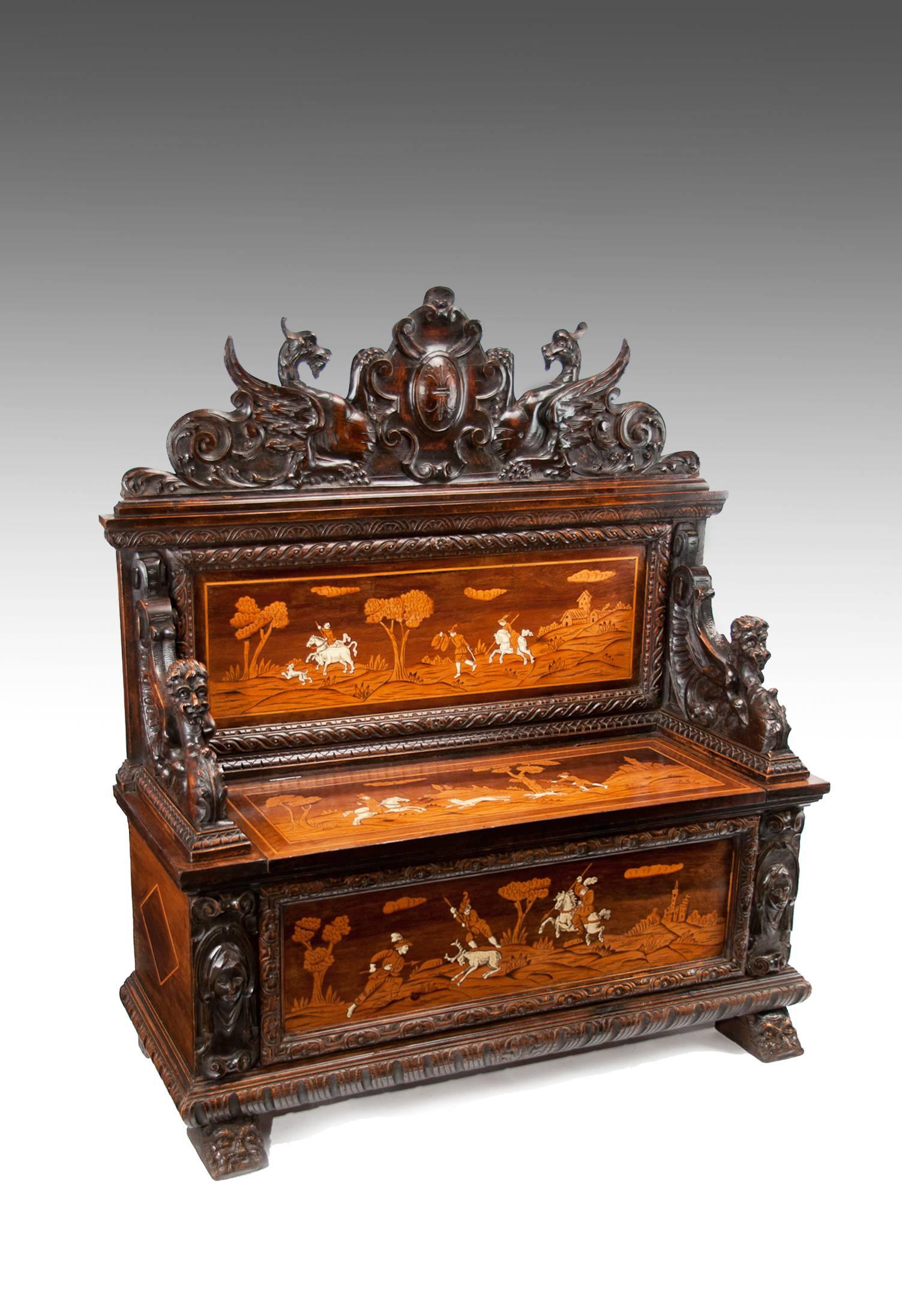 A remarkable ornate antique carved fruitwood Northern Italian (Lombardy) marquetry inlaid cassapanca or hall seat or bench, circa 1850
The raised carved back having a Stemma Nobile or coat of arms flanked by crouching winged dragons (who are
