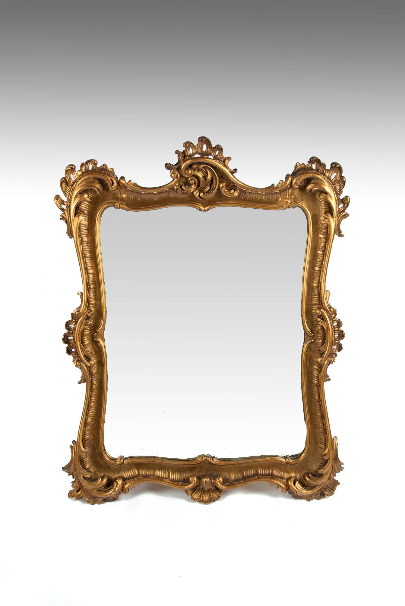 A finely carved and decorative 19th Century giltwood mirror circa 1860.
A very well carved shaped gilt wood hanging wall mirror of good proportions having carved foliage and shell decoration to each corner and centres.
In excellent condition having