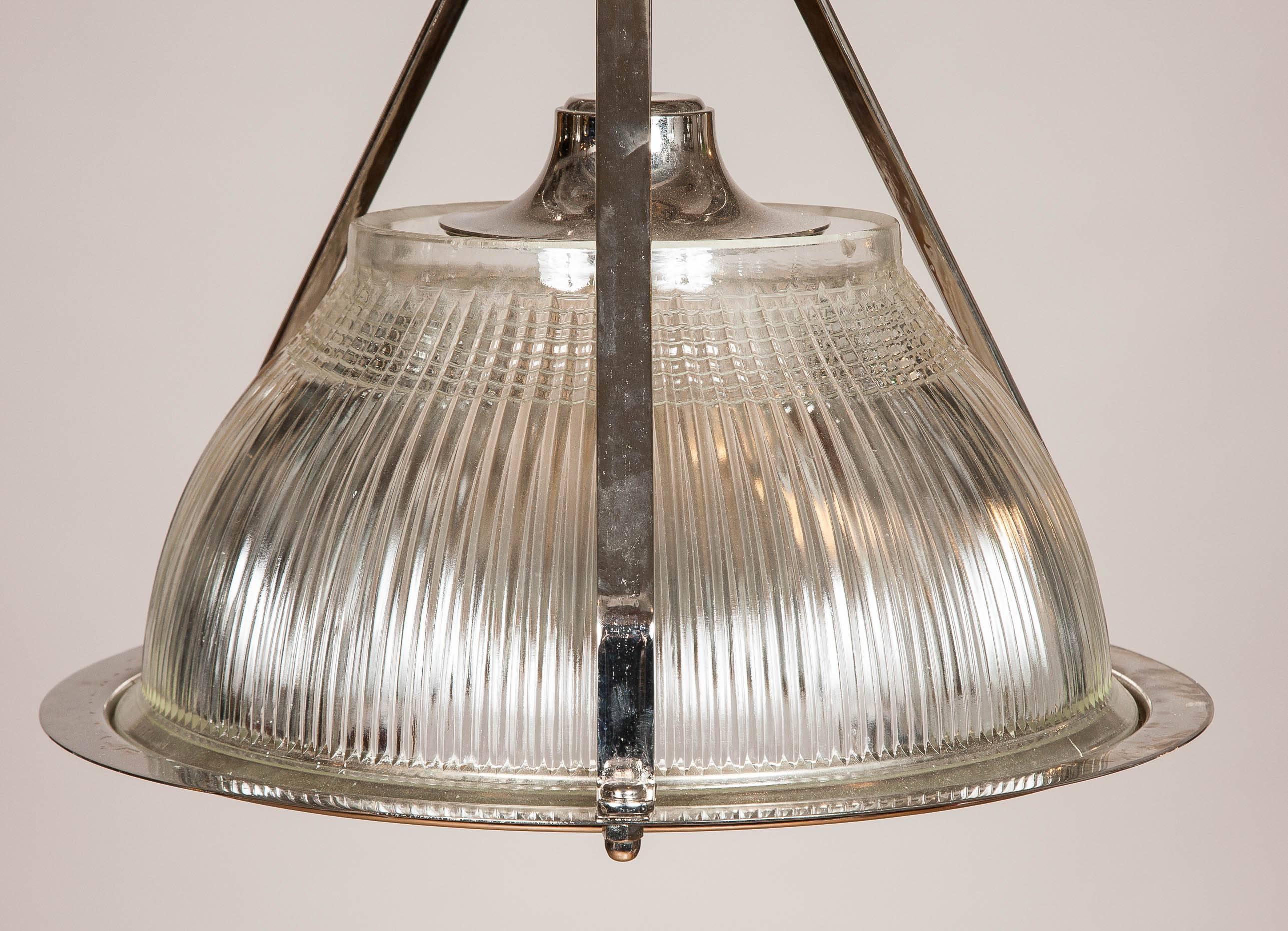 1960s nickel-plated hanging lights formerly used to light aircraft hangers made by Holophane.

Rewired for domestic electricity.

Holophane is a manufacturer of lighting-related products founded in 1898 in London, England. The hallmark of